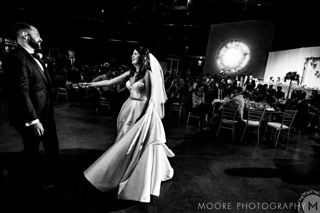 Bride and groom joyfully dancing at a Winnipeg wedding venue reception.