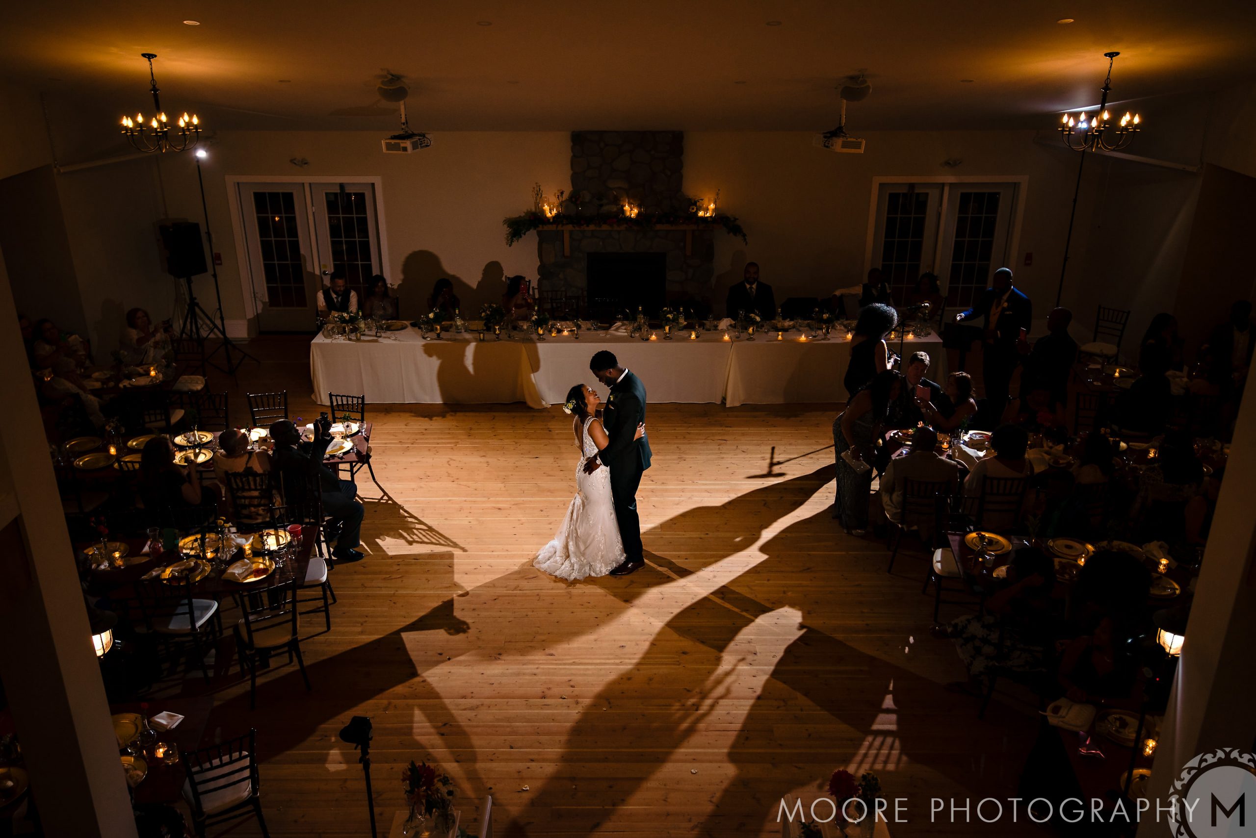 A couple dances in a warmly lit Winnipeg wedding venue.