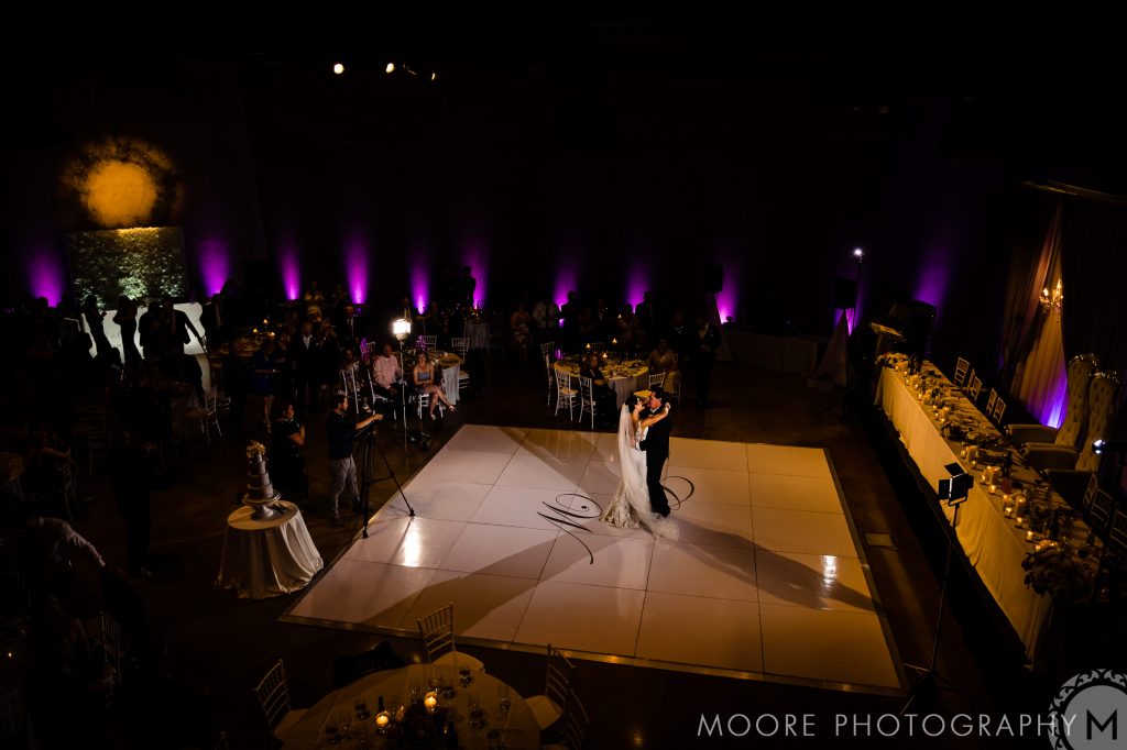 A couple dances on the lit floor at a dimly lit Winnipeg wedding venue.
