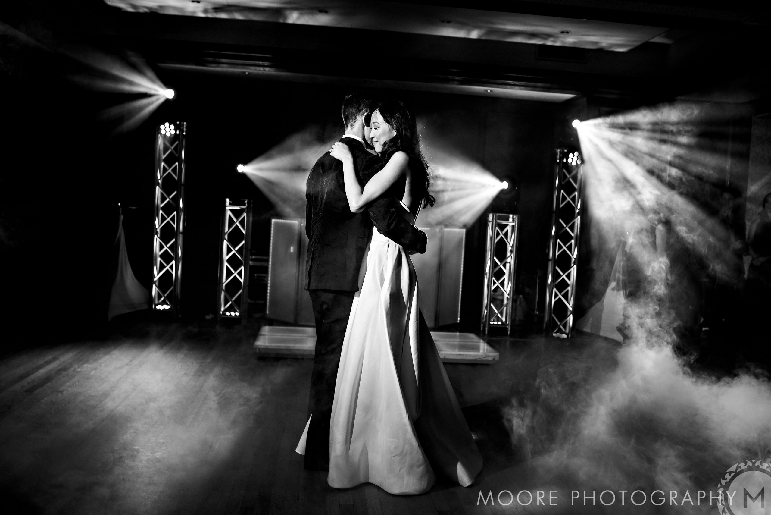 Bride and groom share a romantic dance on a foggy, light-filled Winnipeg wedding venue.