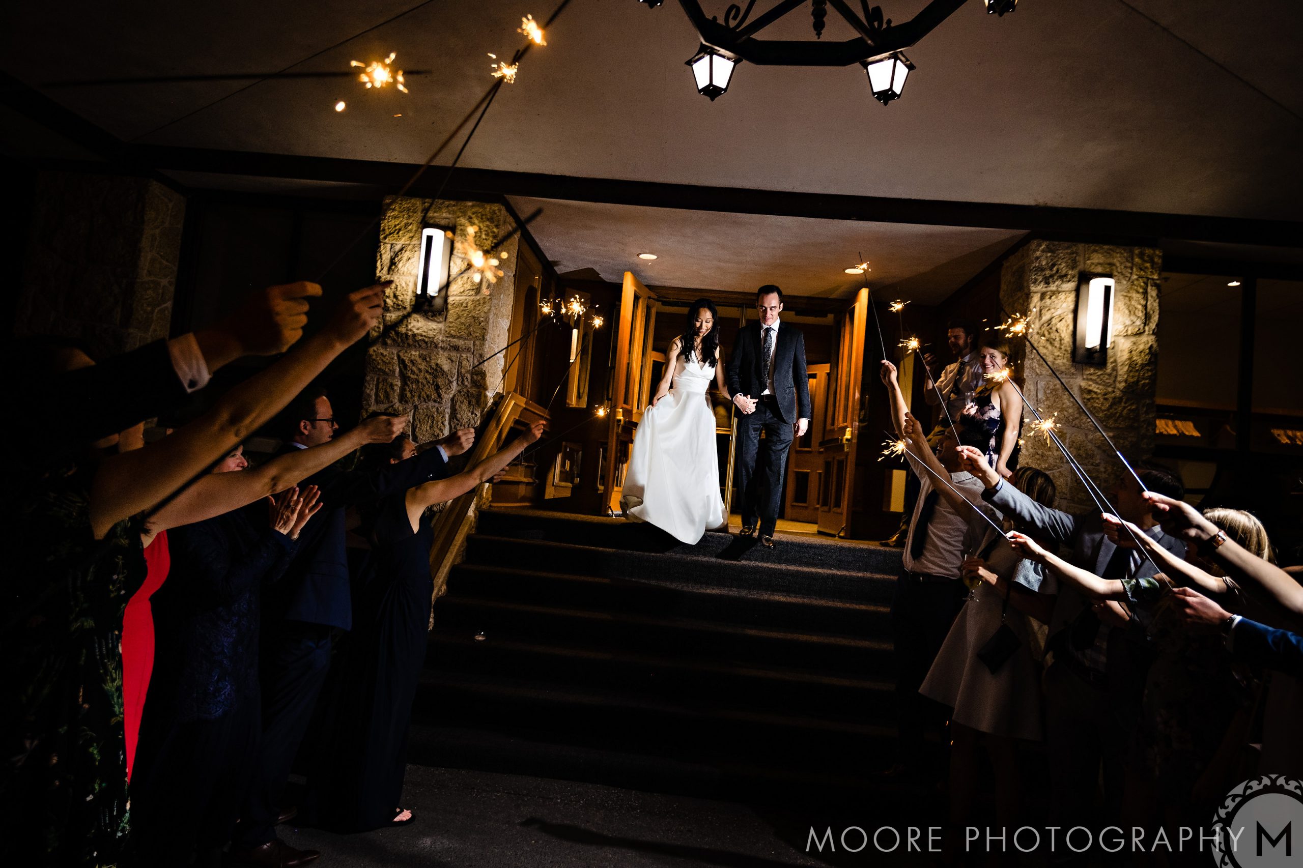 Newlyweds exit through sparklers at night, a magical Winnipeg wedding venue moment.