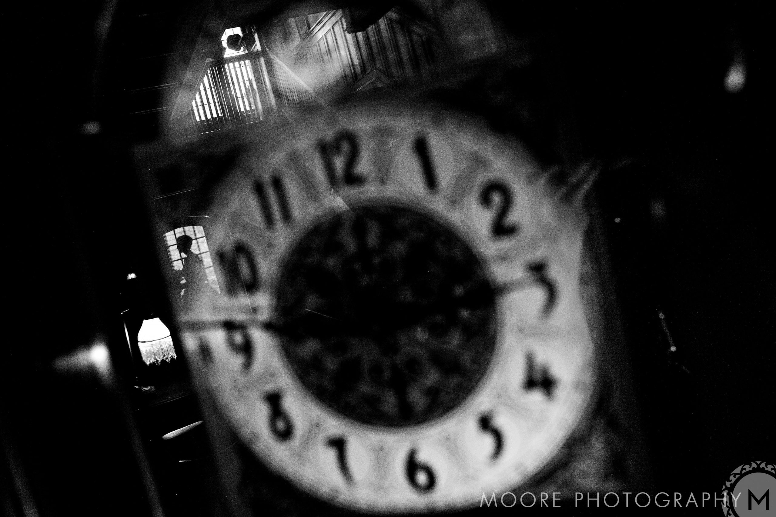 A black and white image of a clock face plays with light, echoing timeless Winnipeg charm.