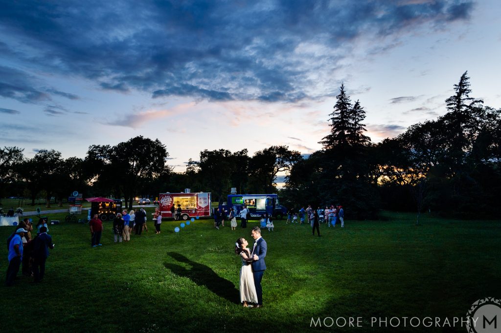 bride and groom dancing in assiniboine park at sunset