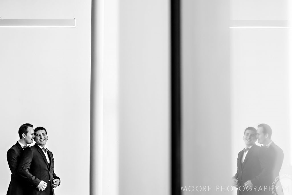 aur wedding couple embracing and smiling in a black-and-white photo