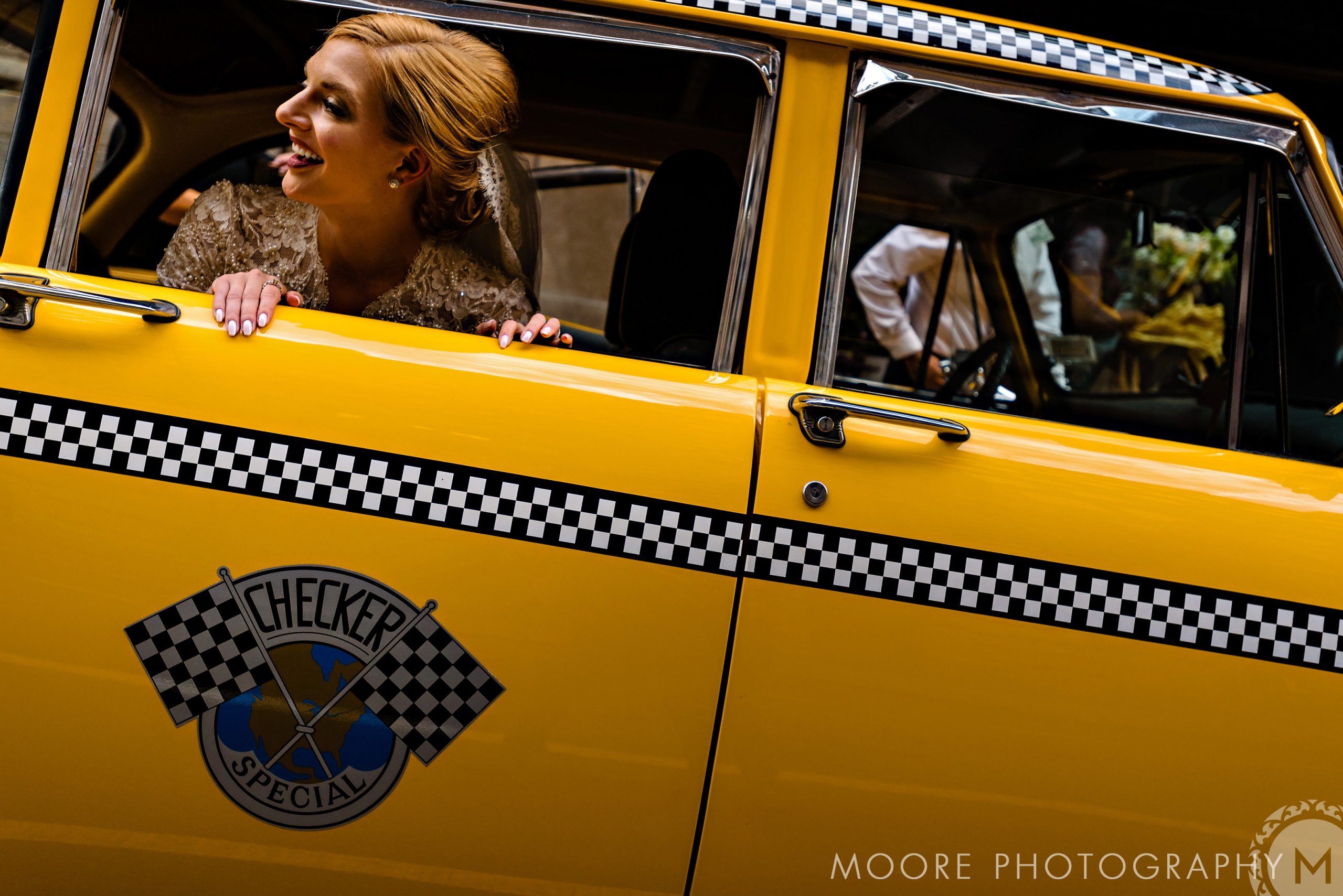 Woman smiling from a yellow taxi in New York City, featuring "Checker Special" logo.