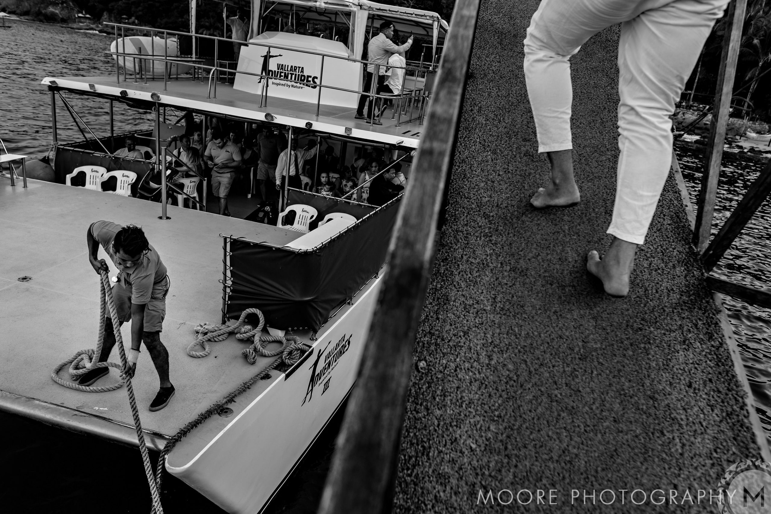 Person walks up a dock ramp to a boat, dreaming of a Puerto Vallarta destination wedding.