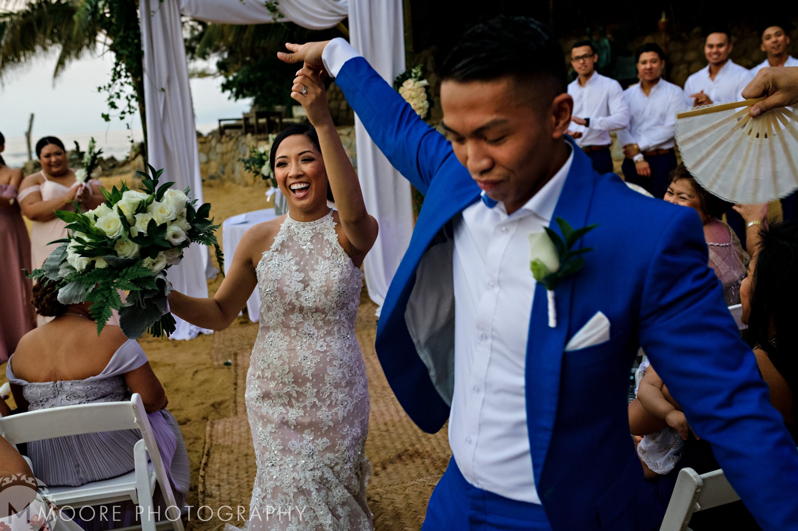 Bride and groom joyfully dance down the aisle at Puerto Vallarta destination wedding.