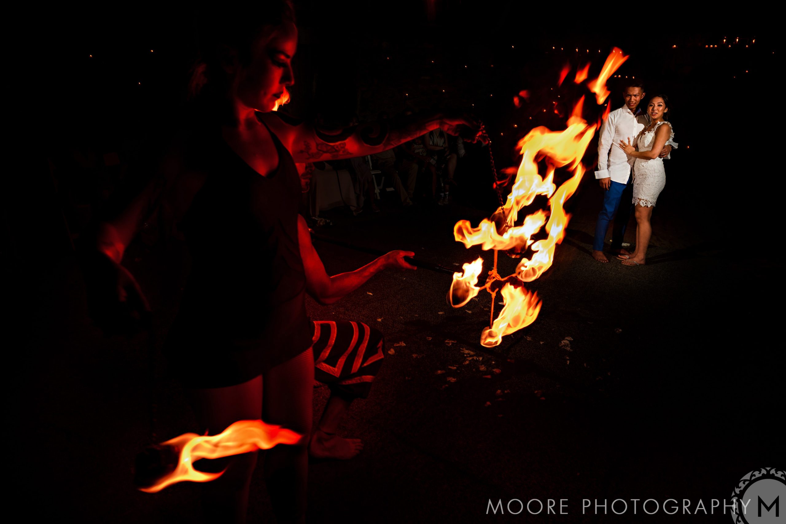 Fire performer dazzles at a Puerto Vallarta destination wedding, flames dancing in the night.