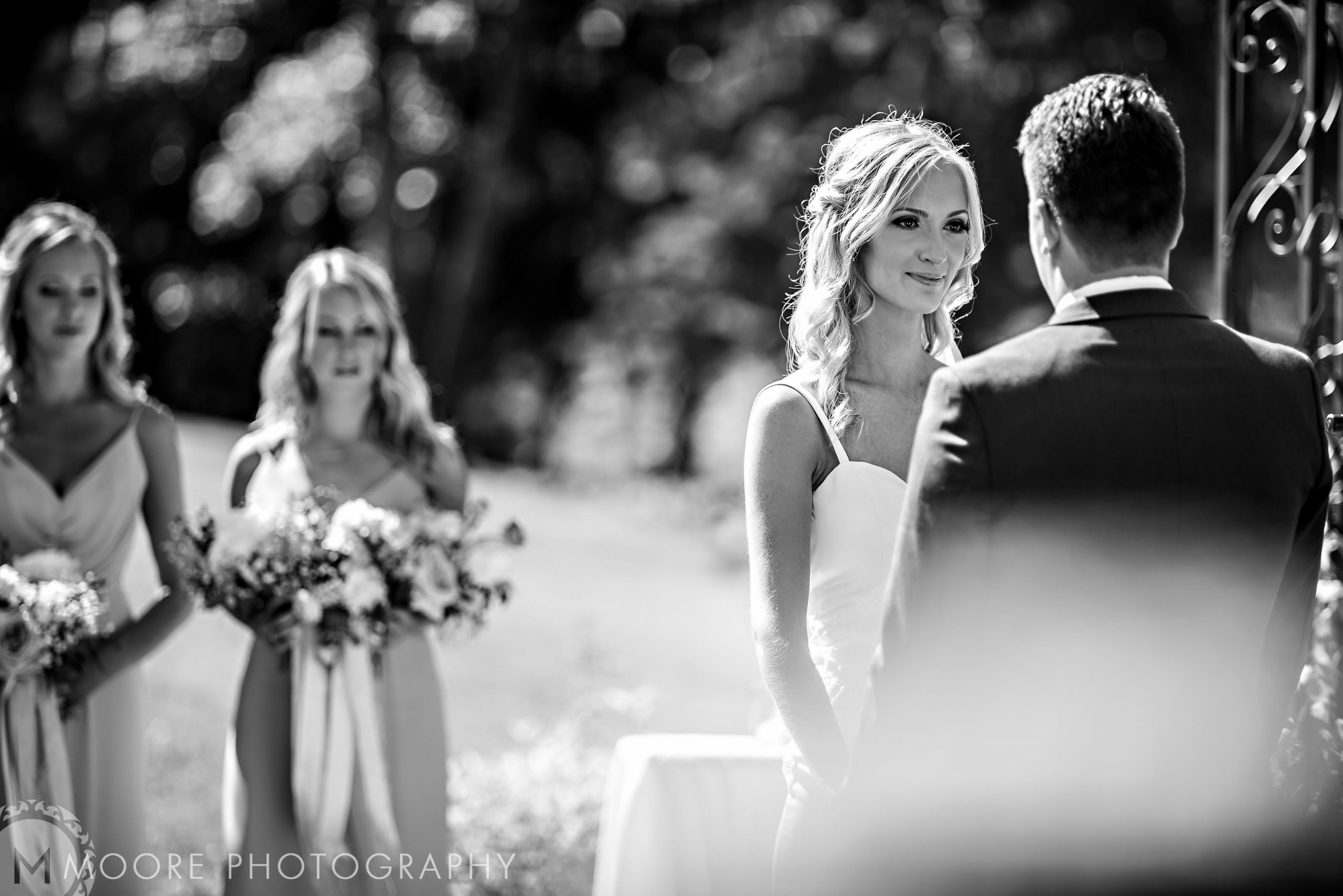 Bride and groom exchange vows outdoors at charming Winnipeg wedding venues.