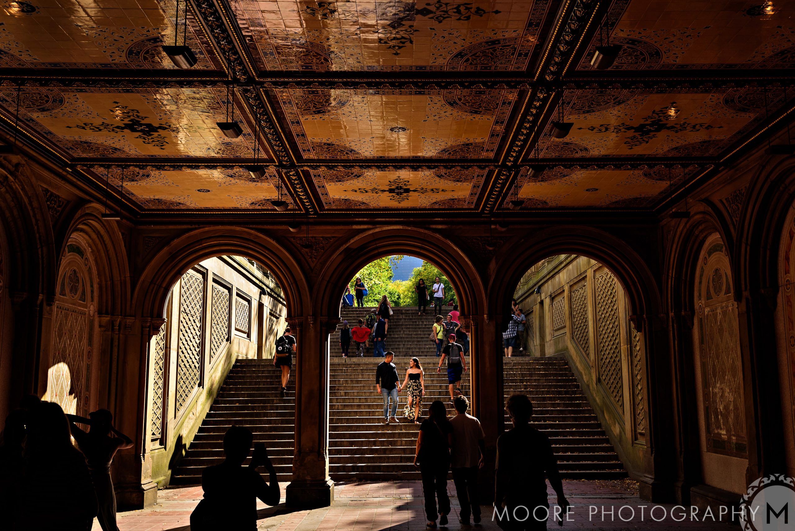 Couple strolling through Bethesda Terrace, perfect for romantic NYC engagement photos.