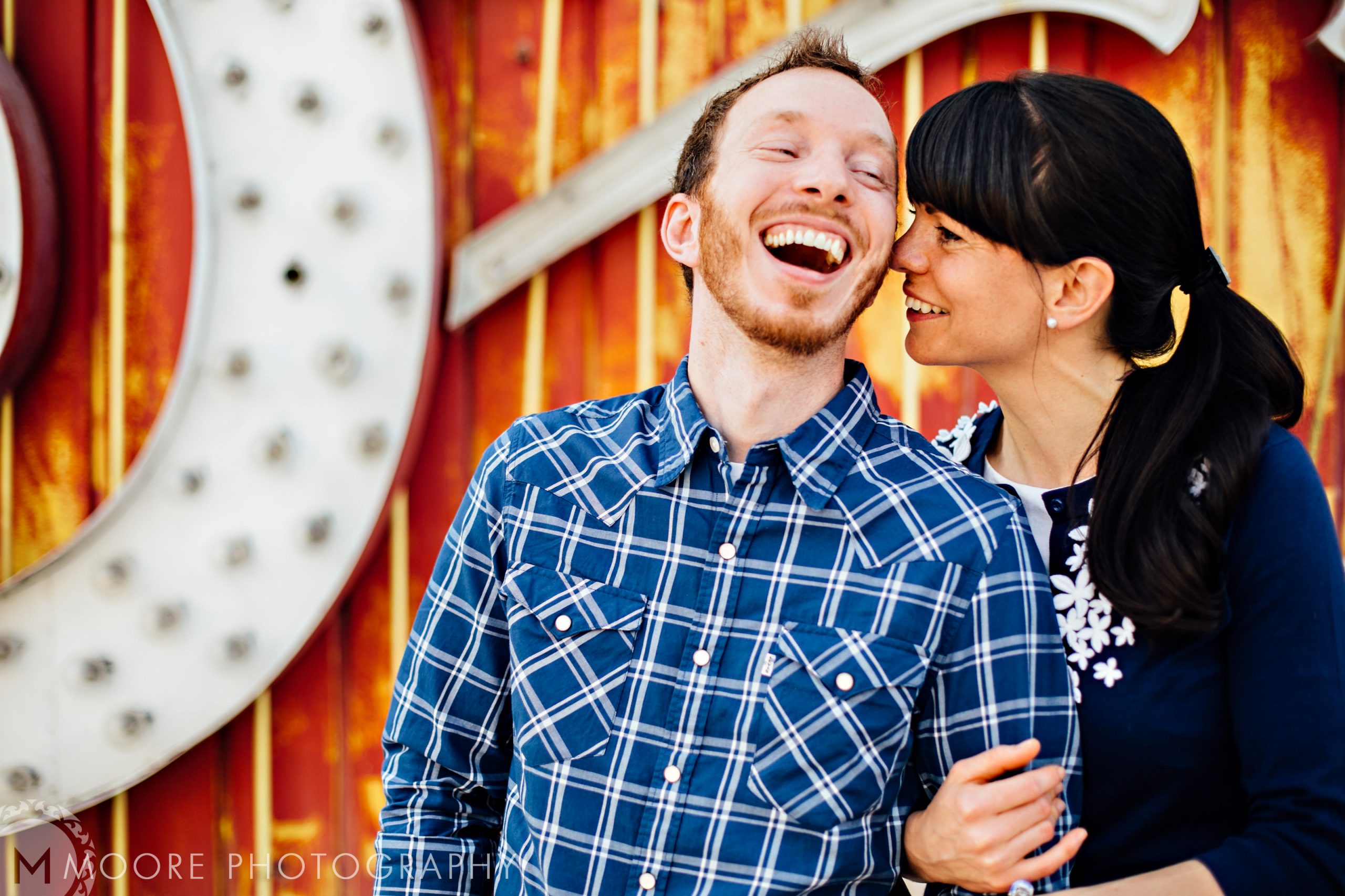 A couple laughing and embracing, captured in vibrant destination wedding photography.