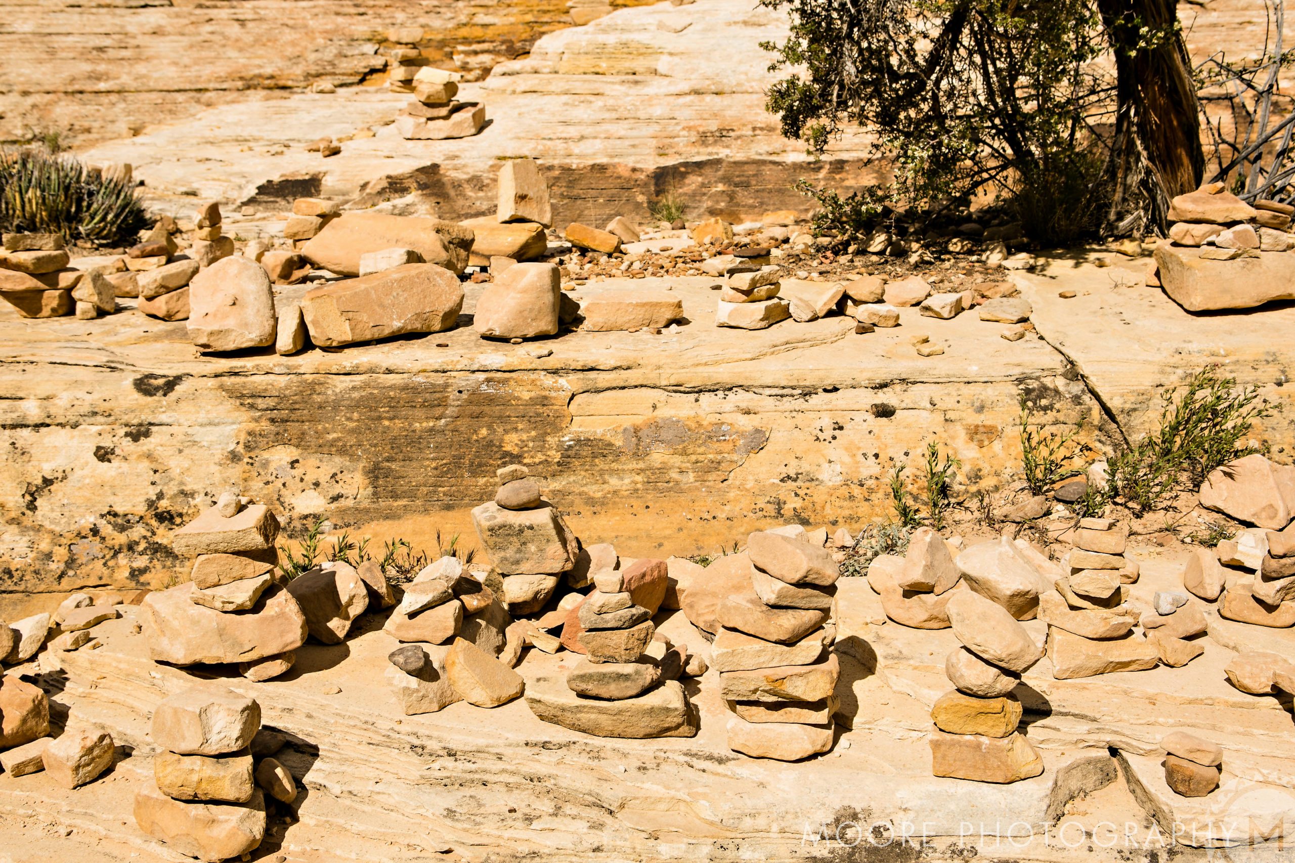 Stacked rocks on a rocky desert landscape, perfect for destination wedding photography.