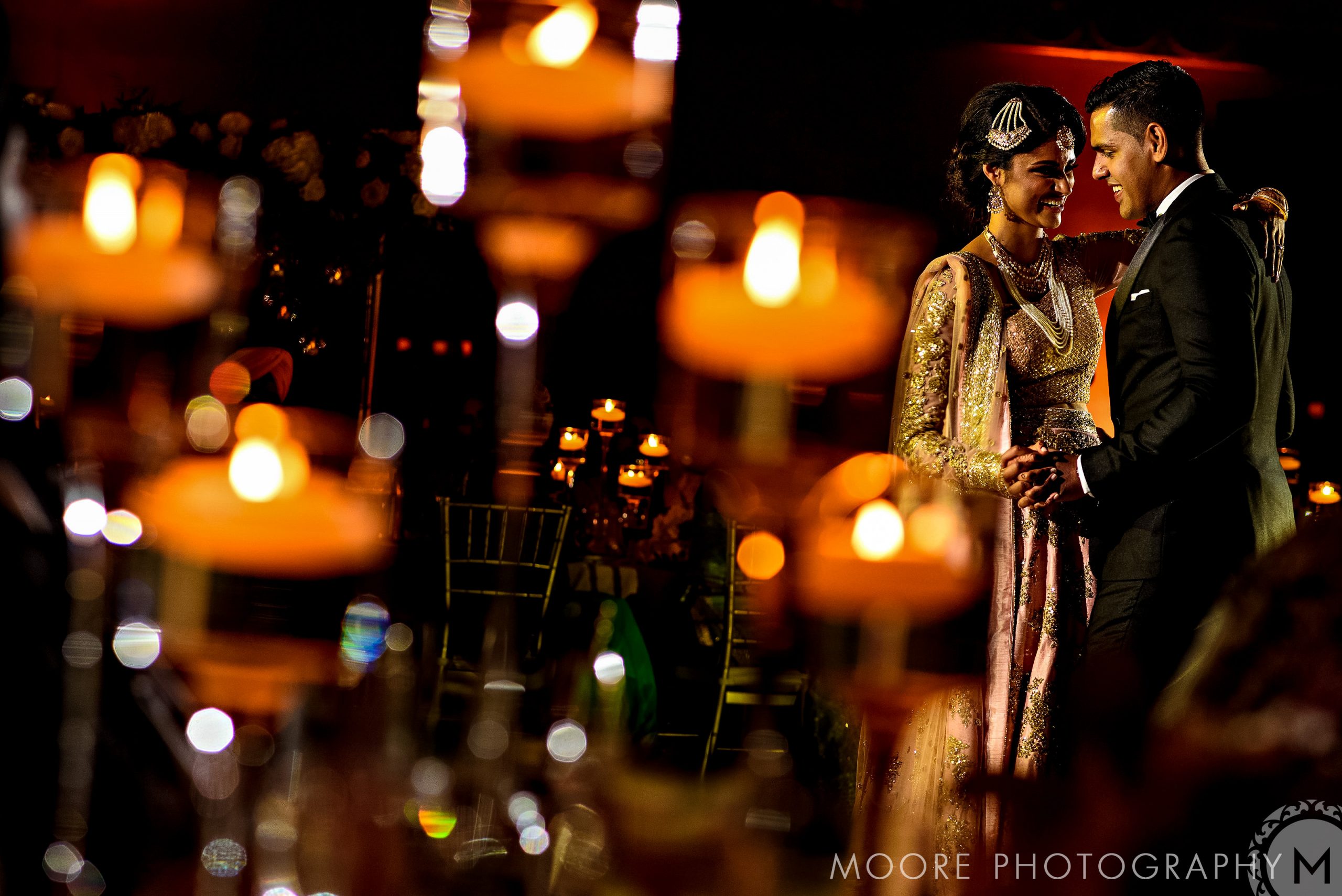 Couple dancing at an elegant Winnipeg wedding venue, surrounded by warm candlelight.