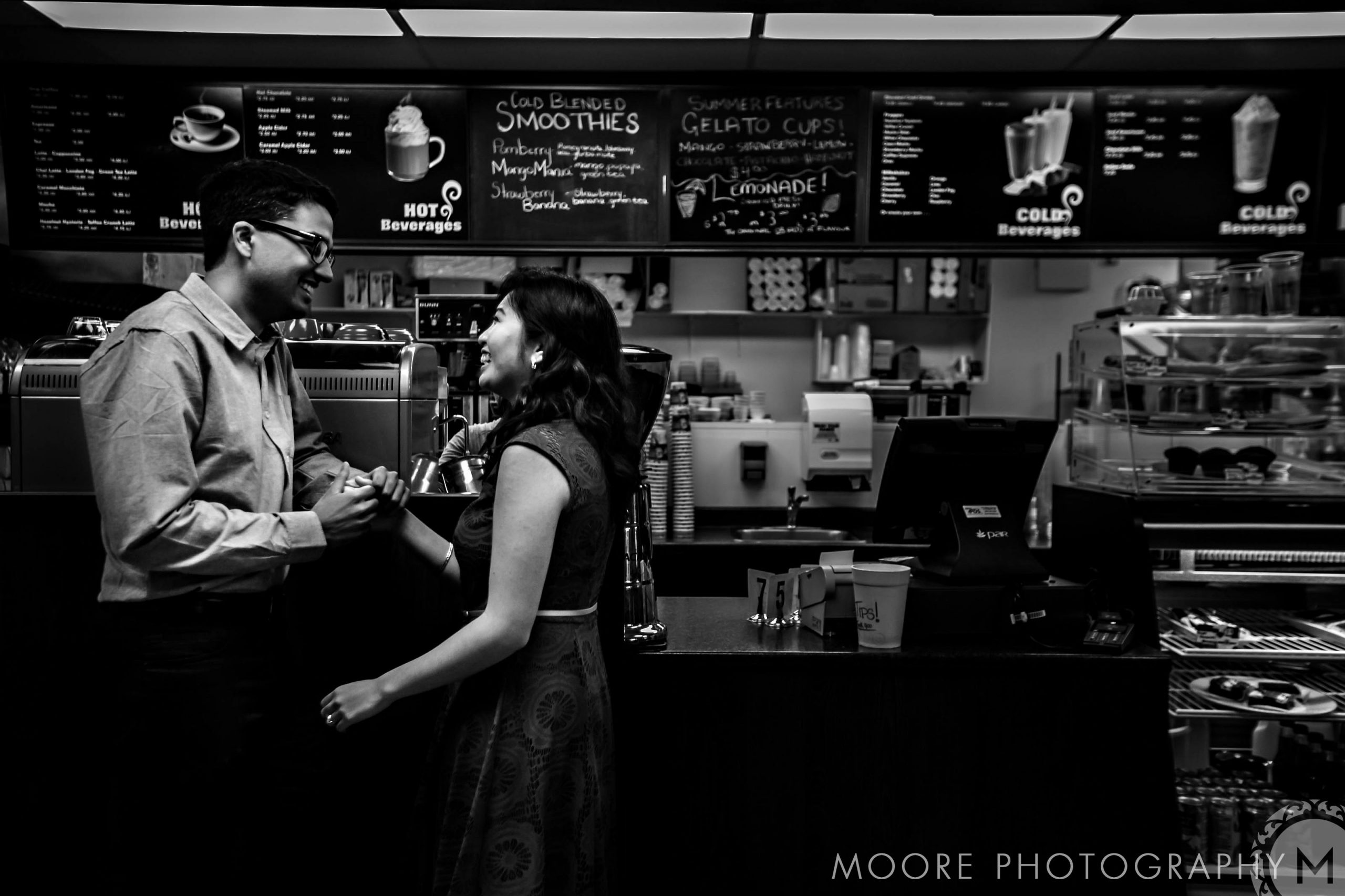 A relaxed couple shares smiles and espresso love in their Winnipeg engagement photo.