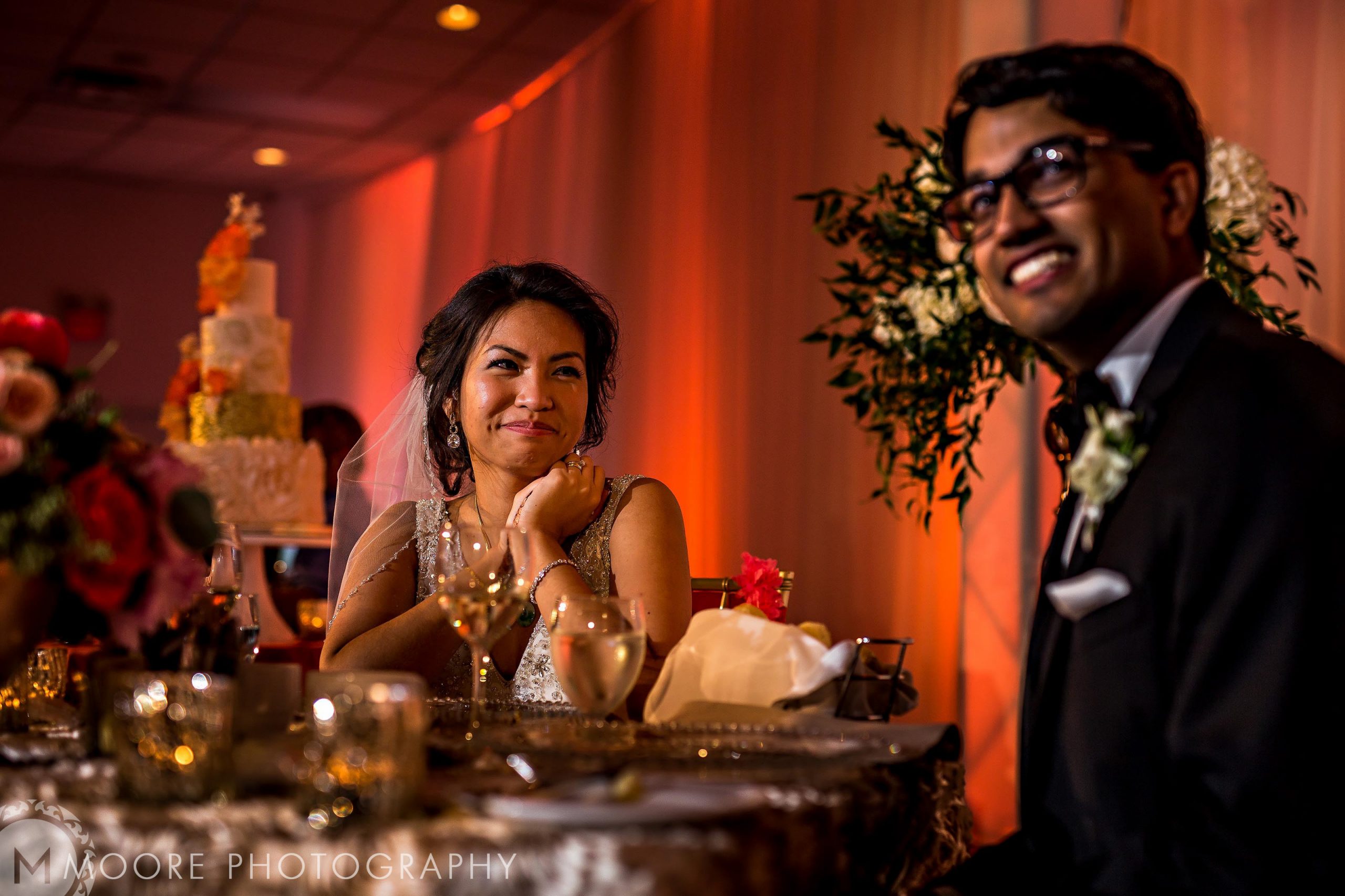 Bride and groom smiling at each other during a Winnipeg wedding reception.