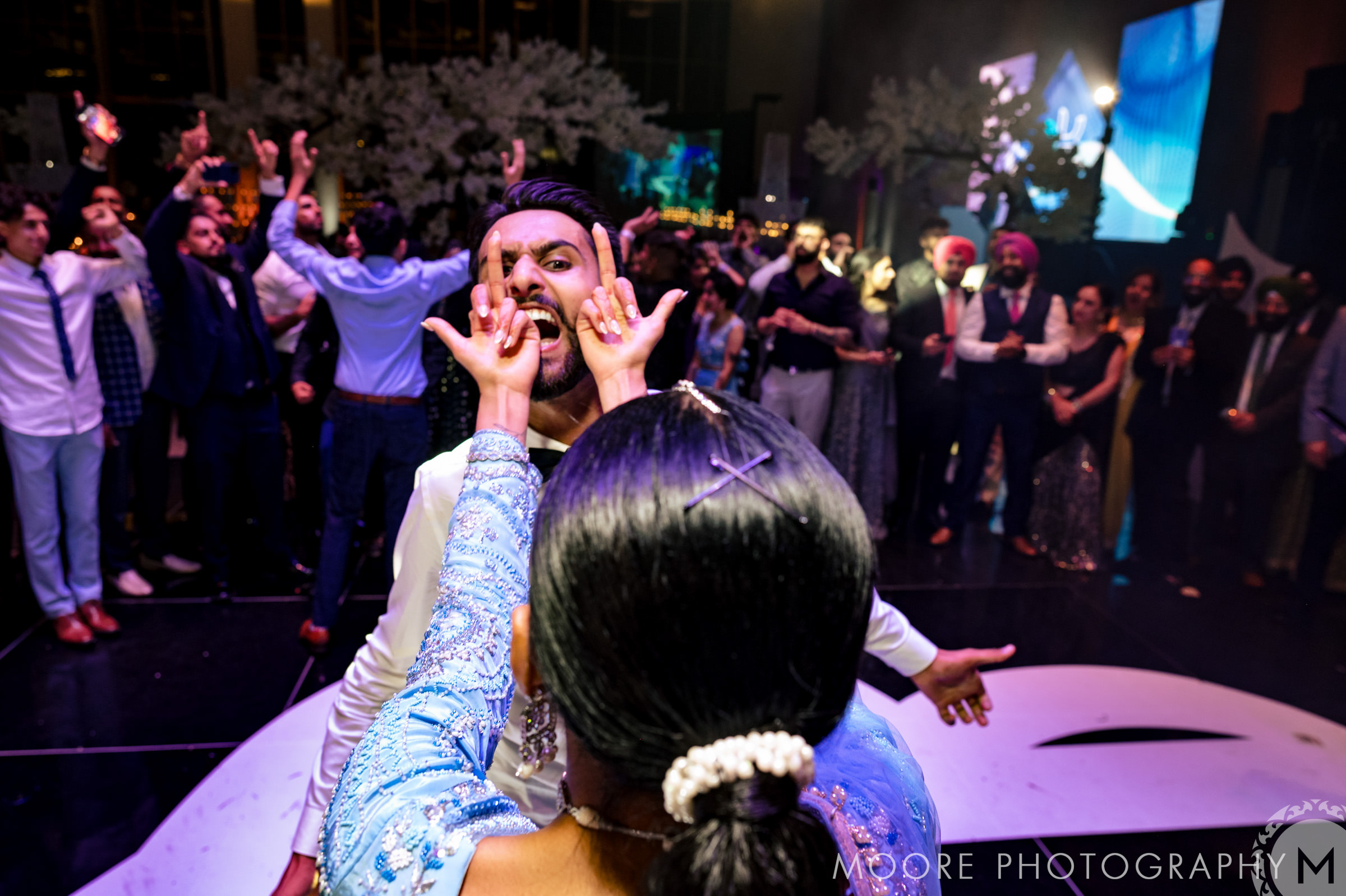 A joyful dance floor scene at a lively Winnipeg wedding celebration.