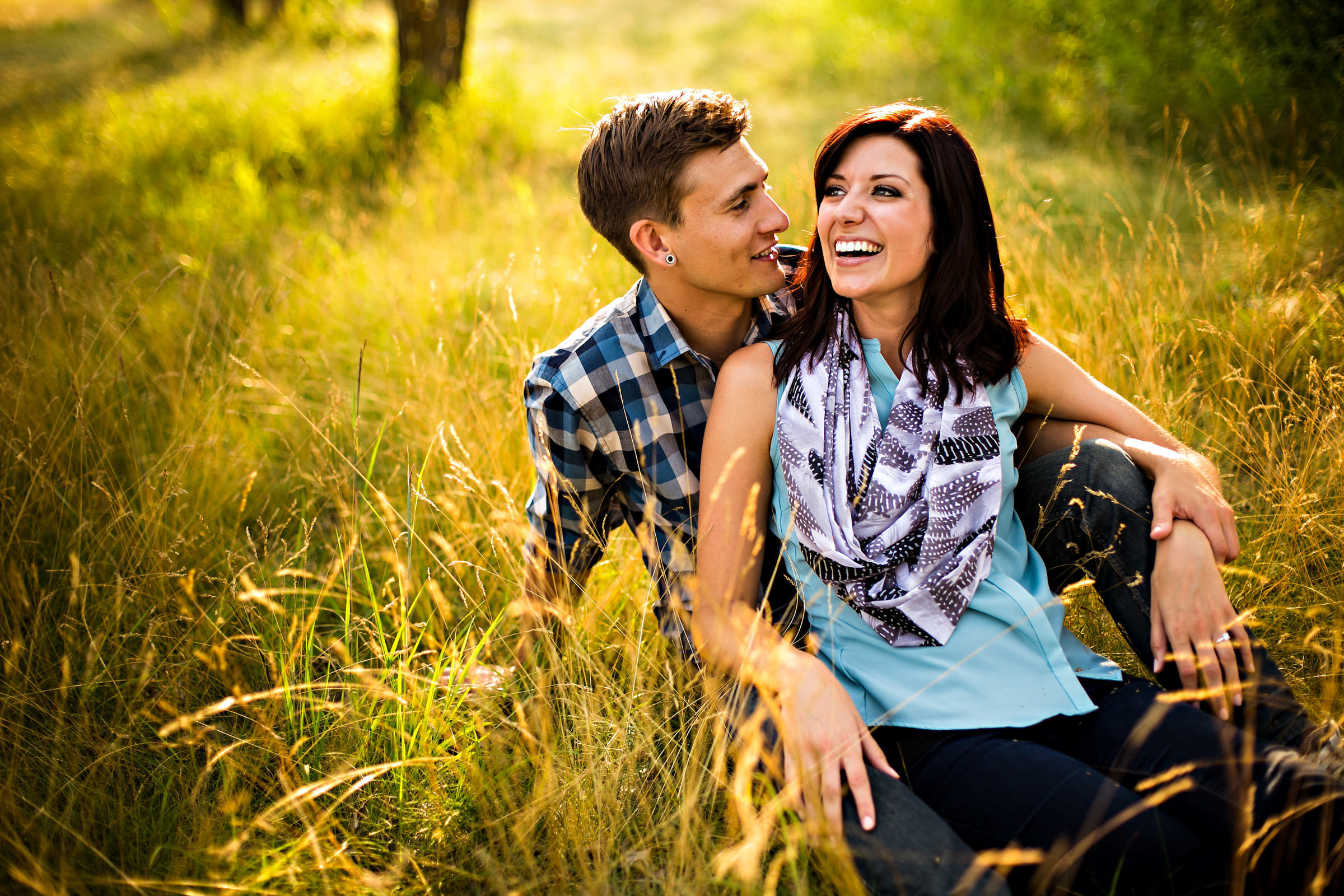 And engaged sitting in the grass, and laughing at Birdsill Park, Manitoba