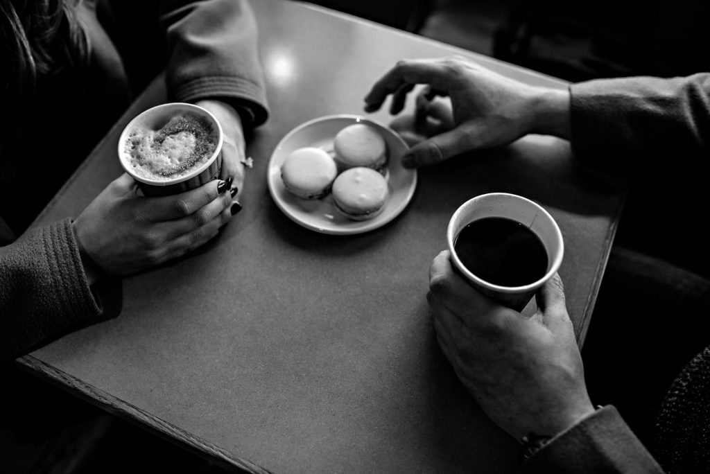 An engaged couple sitting for coffee and treats in Winnipeg Manitoba