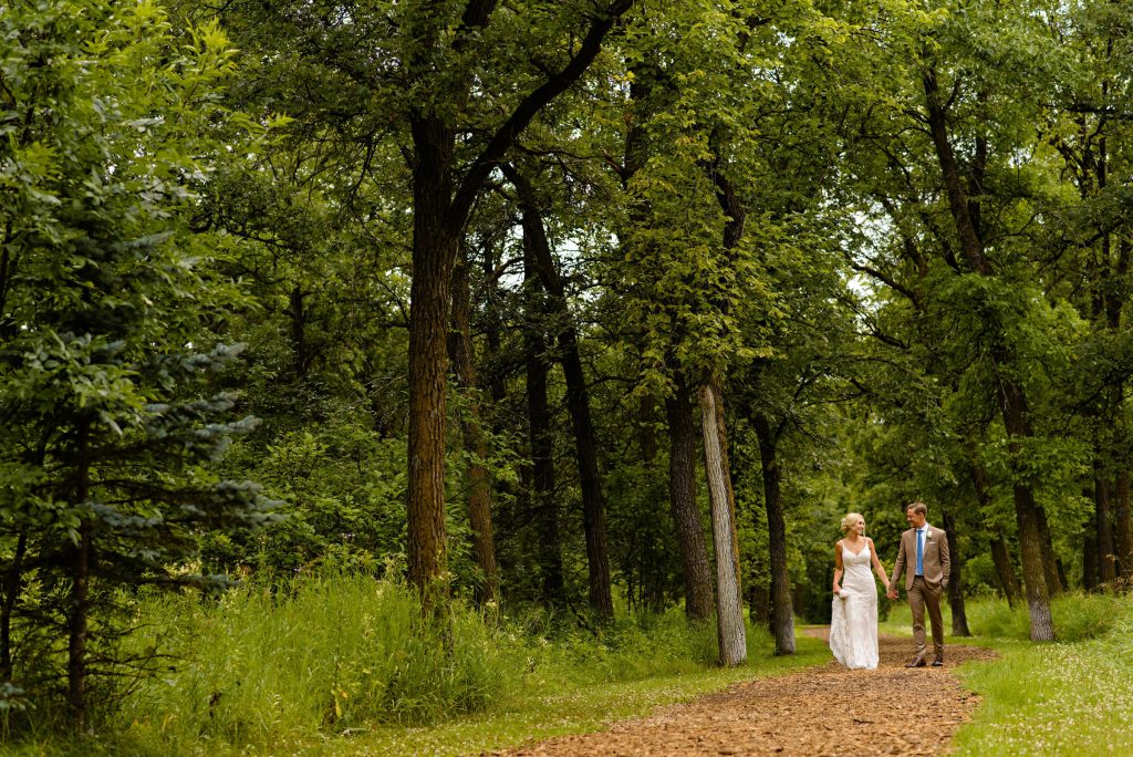Walking and holding hands in the nature park down the path