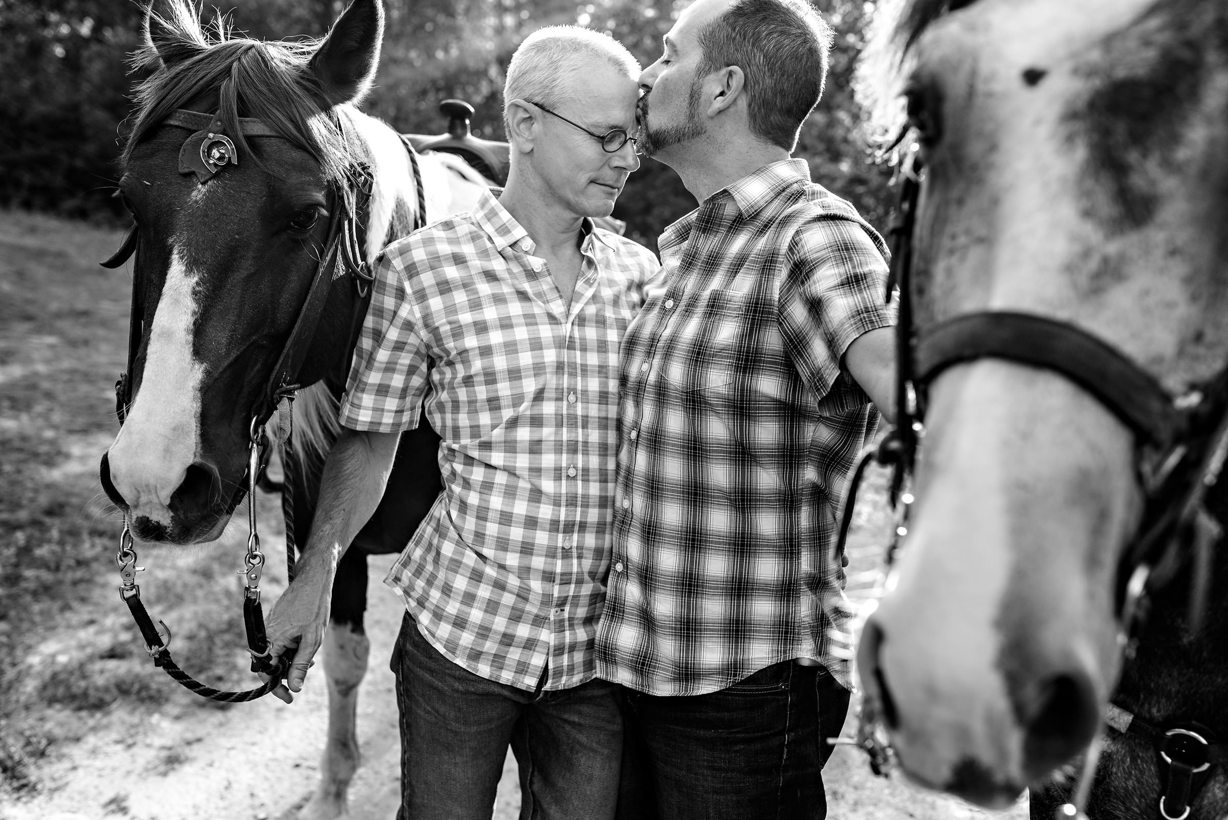 Our homosexual engaged couple, riding horses and kissing during an engagement session