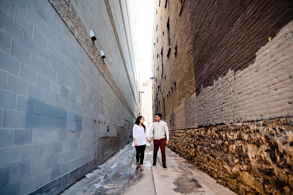 A couple walking through at Bryk alleyway in the Winnipeg exchange district