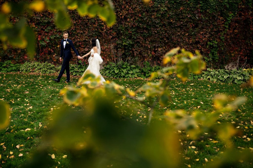 Bride and groom through a botanical garden in Winnipeg Manitoba