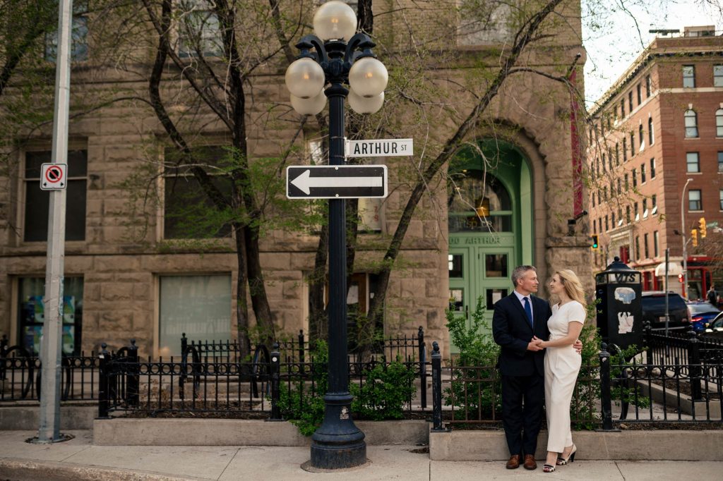 A bride and groom posing for a wedding photo in the Winnipeg downtown exchange district