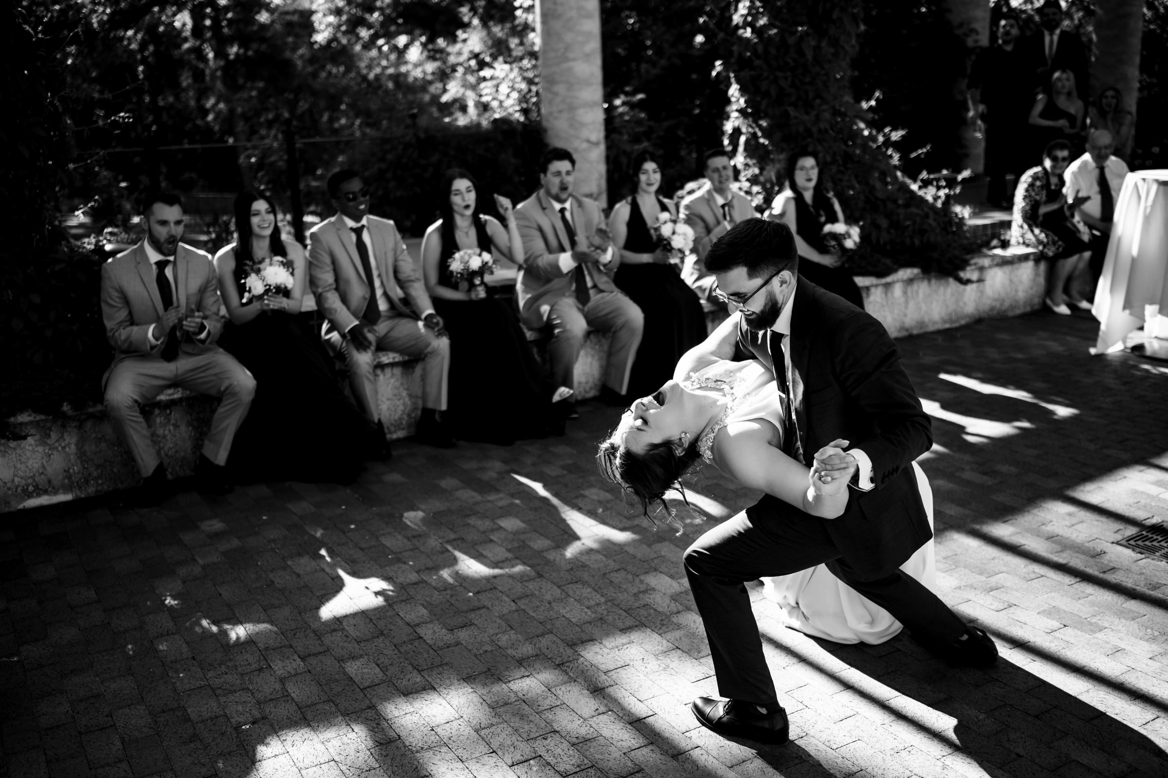A couple dances passionately outdoors at one of Winnipeg's stunning wedding venues.