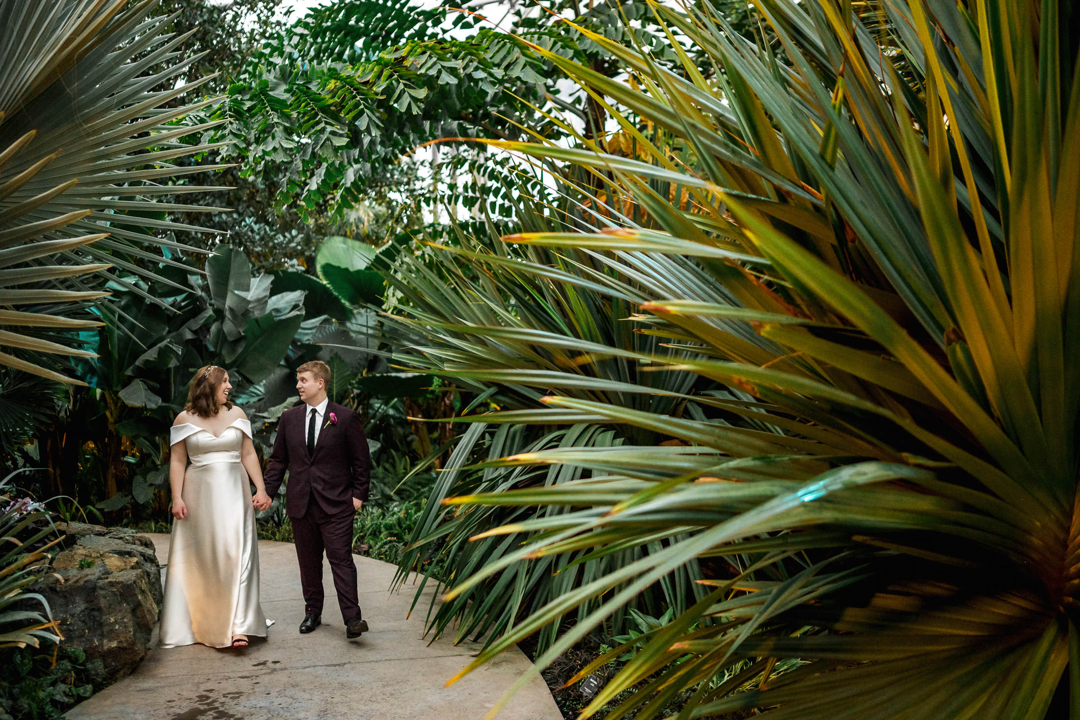 A couple strolls hand in hand, as if captured in winter wedding photos at The Leaf.