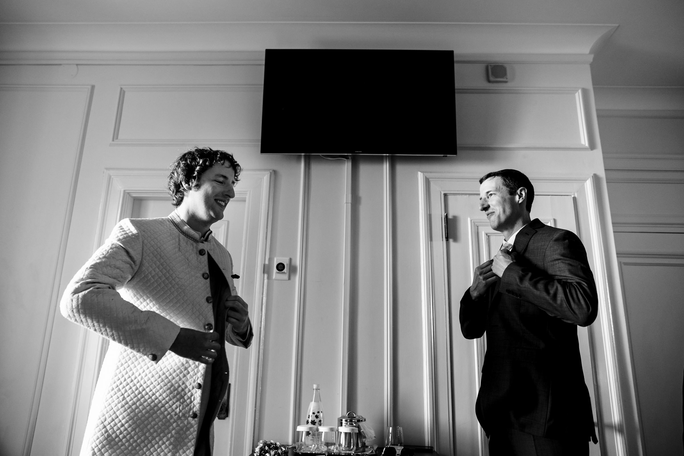 a groom and his brother getting ready on his wedding day at the fort garry hotel