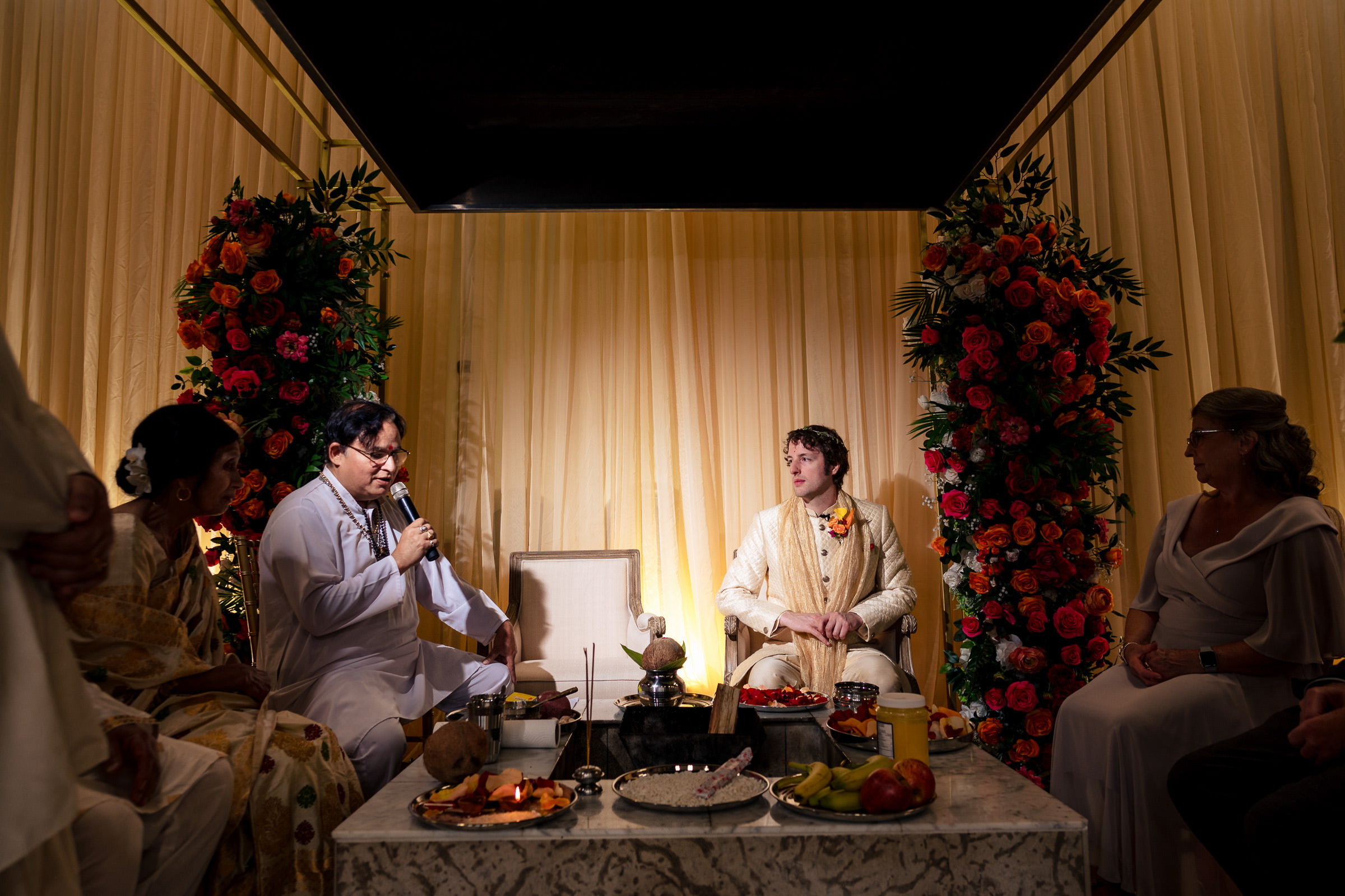 A bride and groom in traditional attire at a Winnipeg wedding with guests around.
