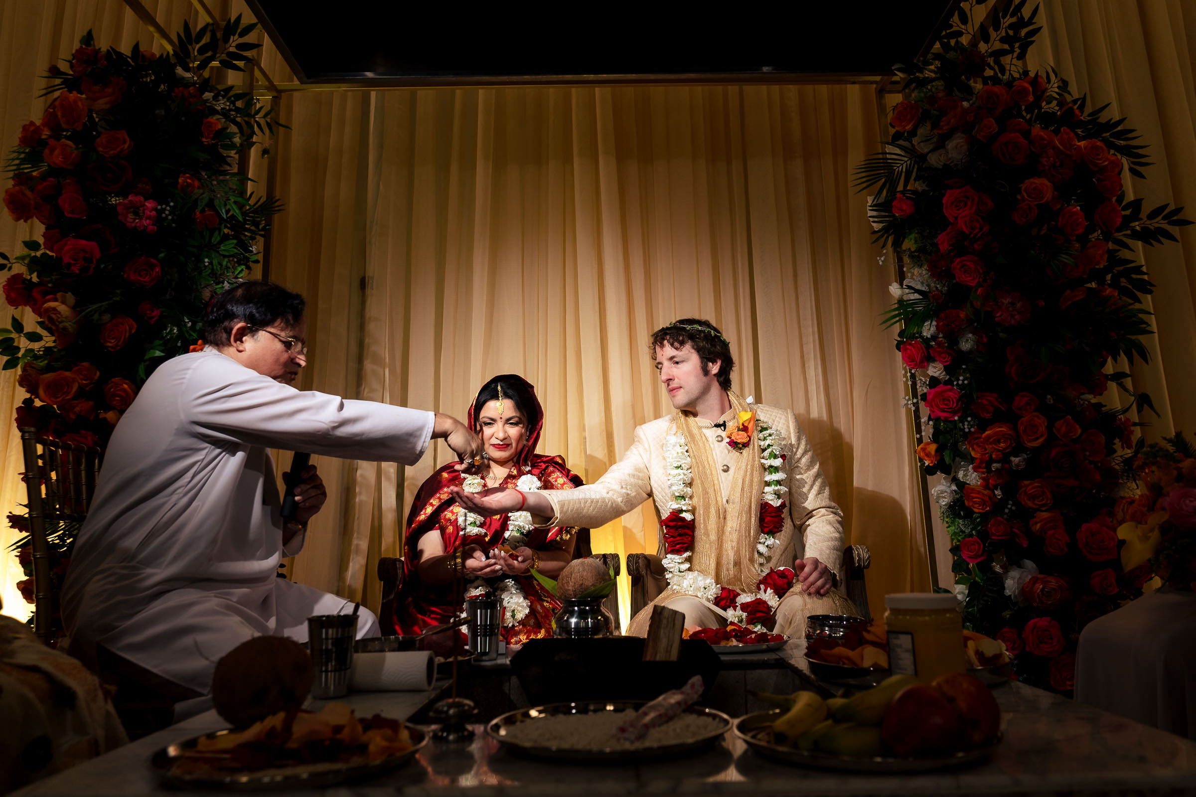 Winnipeg wedding ceremony with a couple, officiant, and floral decorations.