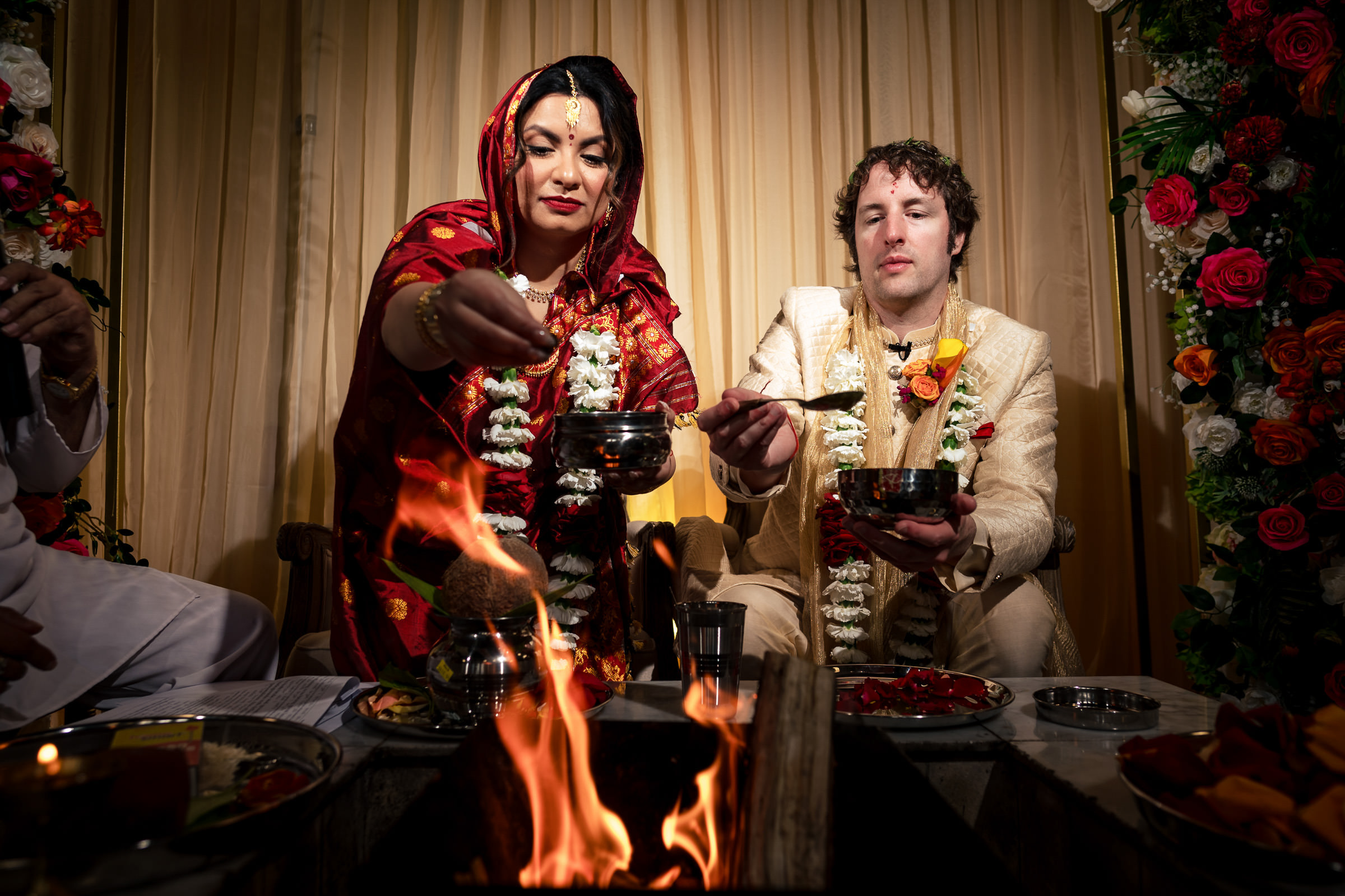 A couple enjoys a traditional Winnipeg wedding with fire and floral decorations.