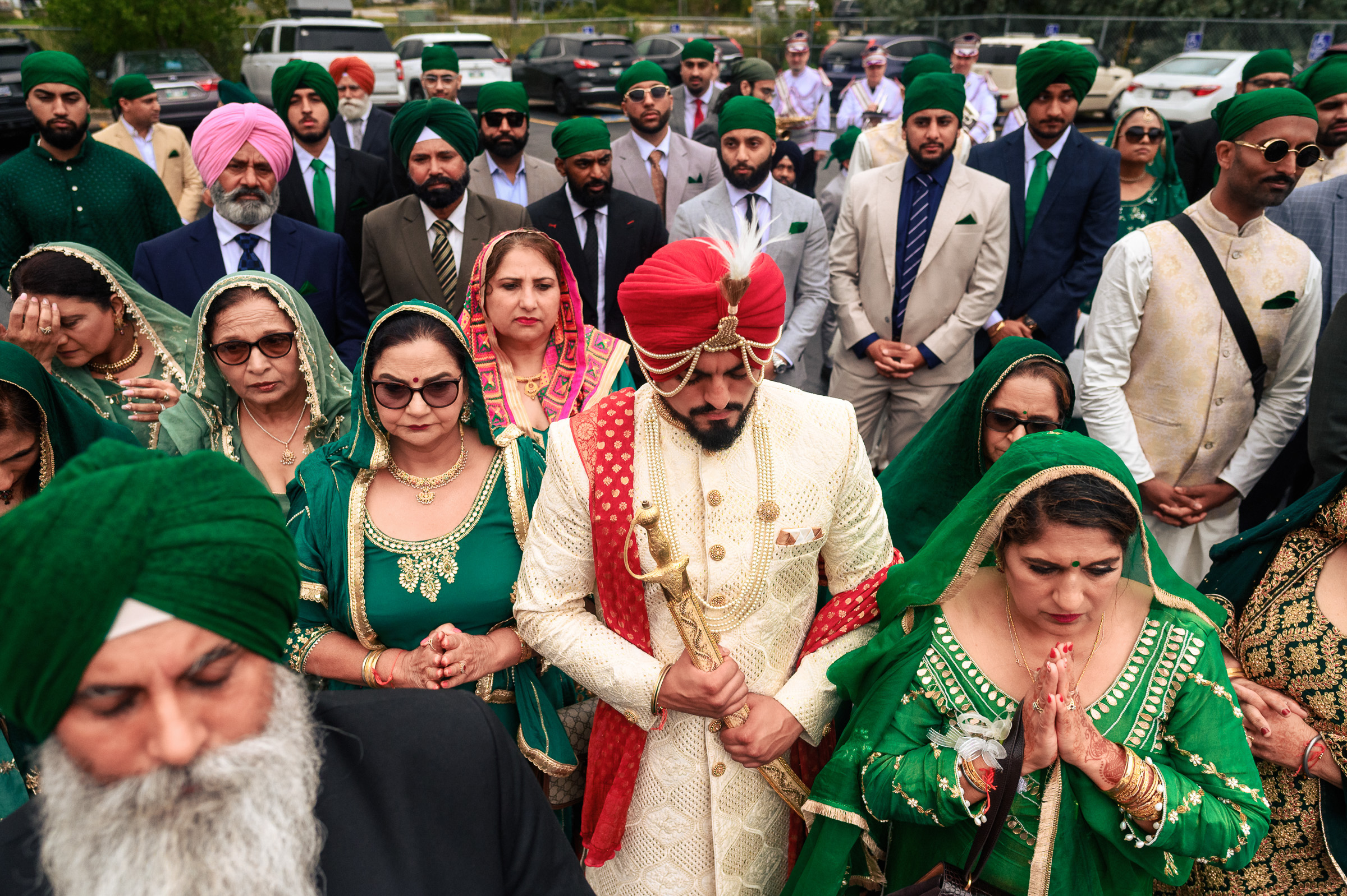 A group of people wearing traditional Indian attire at an outdoor gathering.