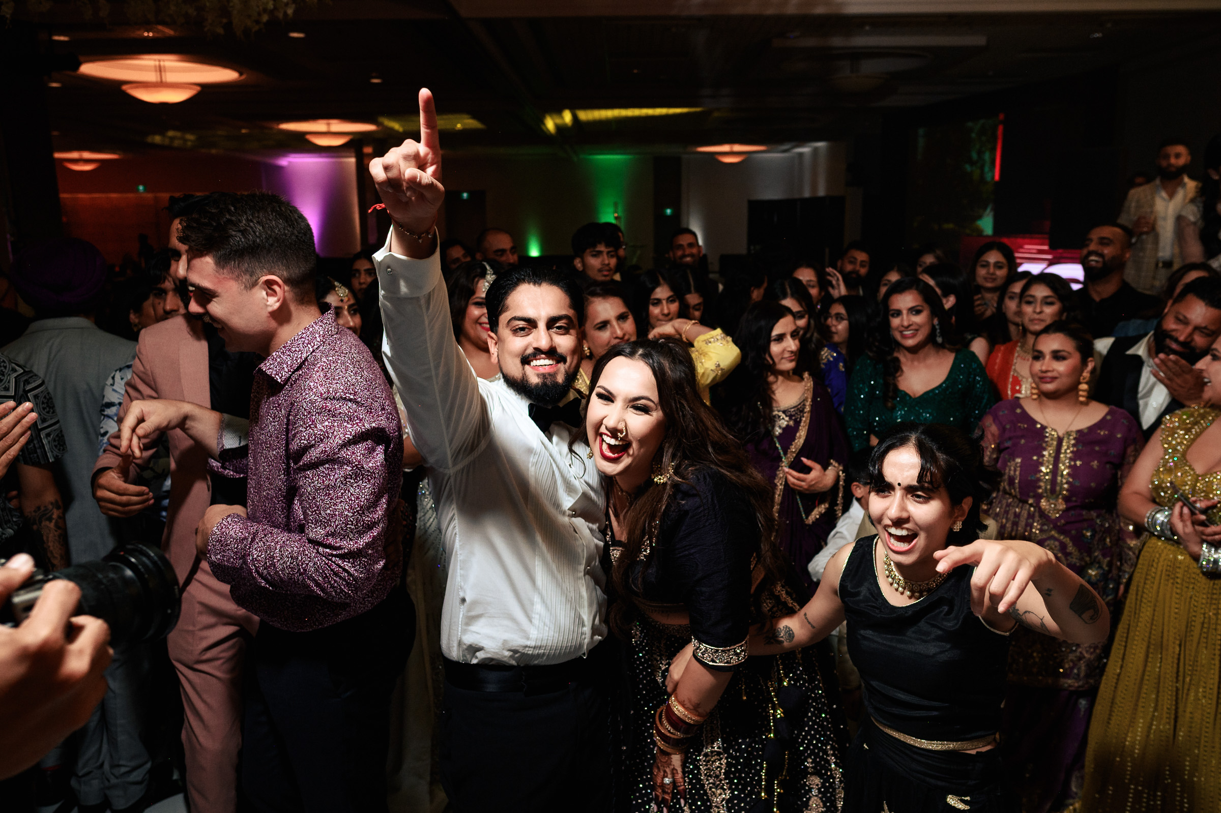 A group of people celebrating at a lively indoor party.