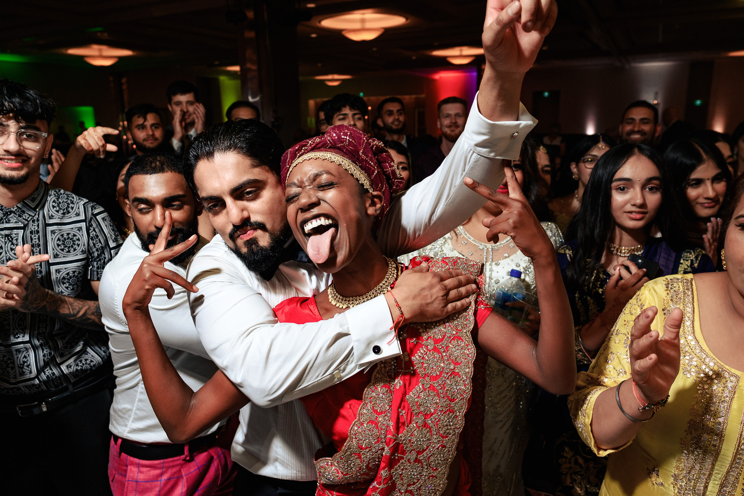 People dancing and posing together happily at a party.