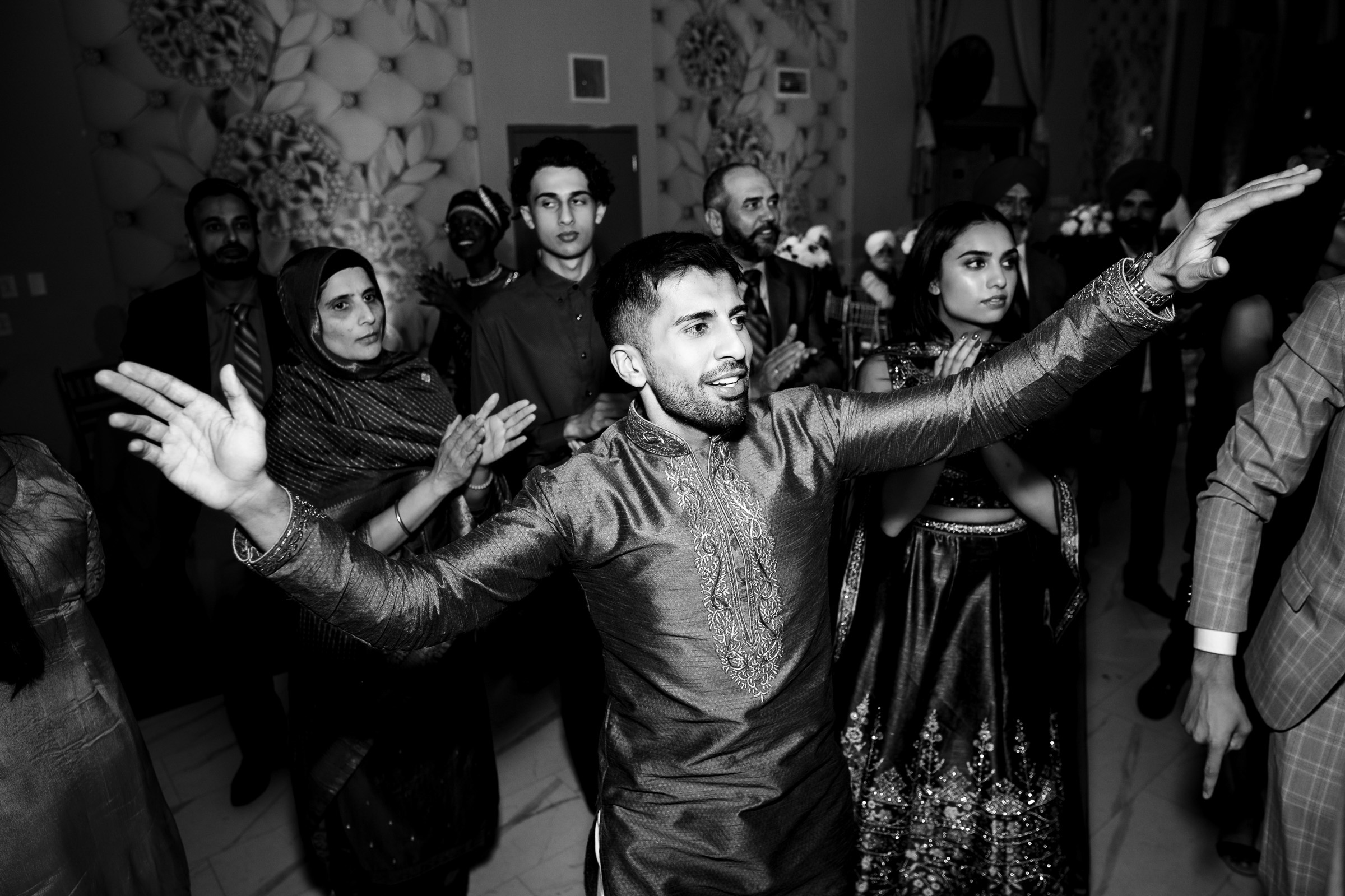 People dancing enthusiastically at a lively indoor event.