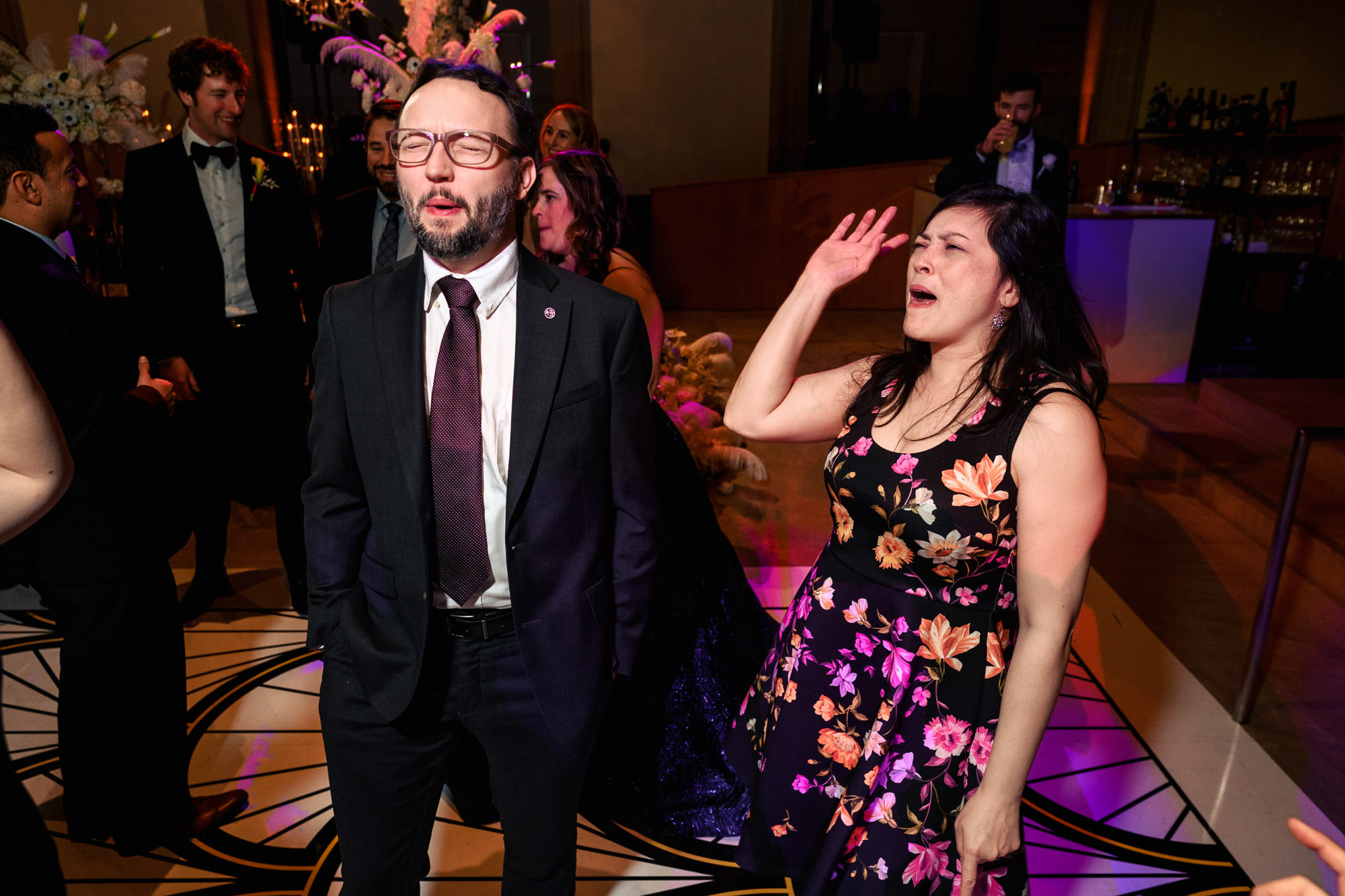 People singing and enjoying a lively party at an Art Gallery of Ontario wedding.