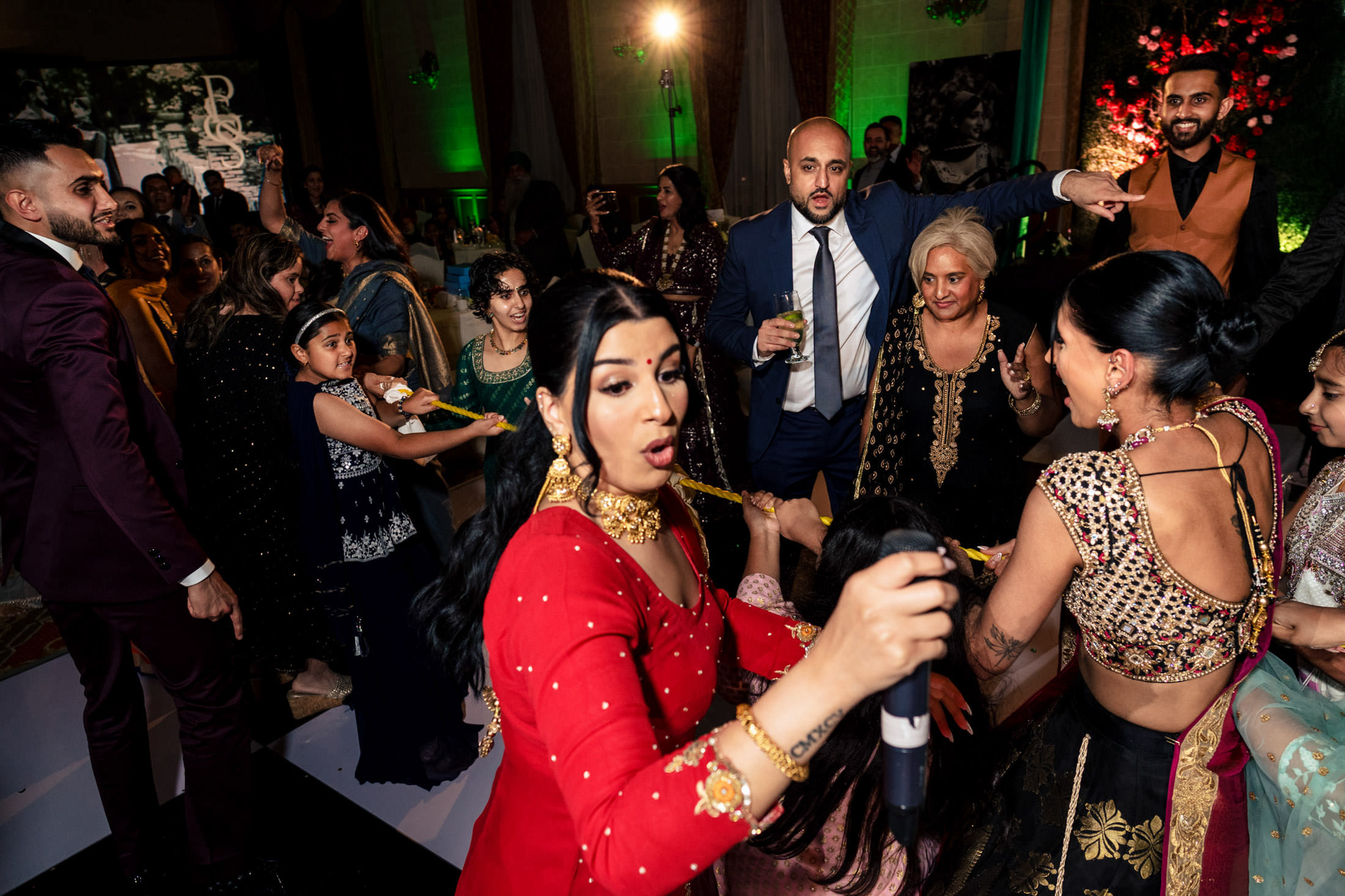 Lively group dancing energetically at a Winnipeg wedding celebration.