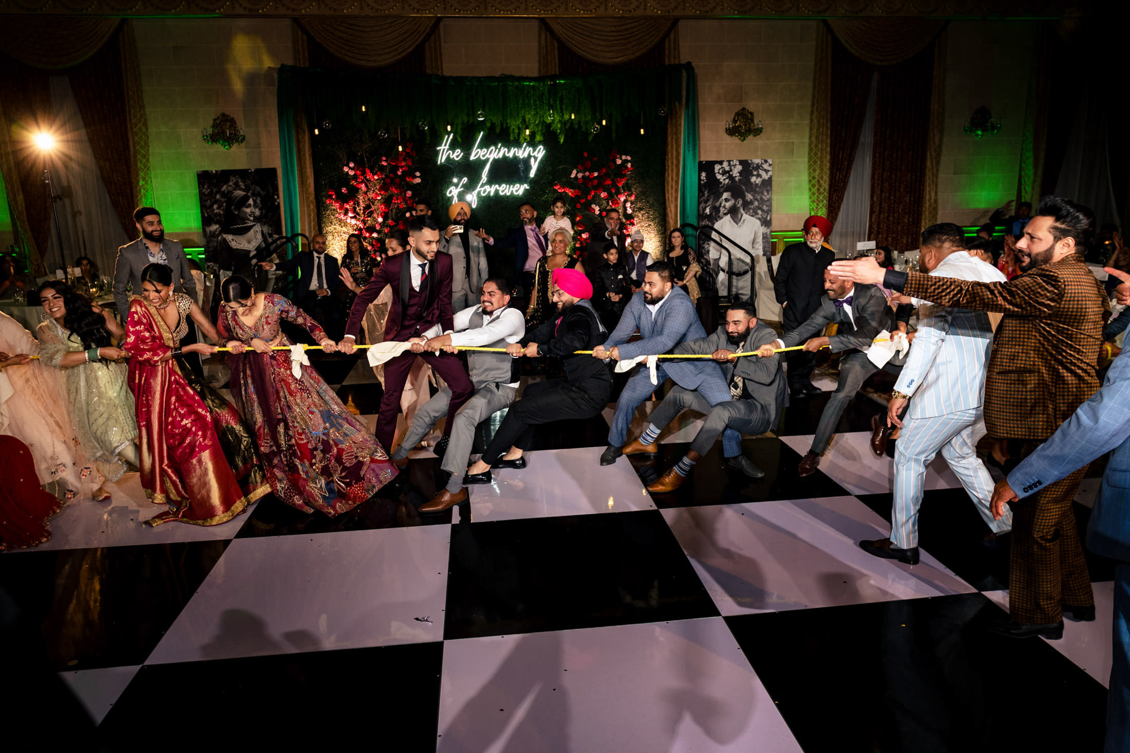 Guests in formal attire play tug-of-war at a memorable Winnipeg wedding event.