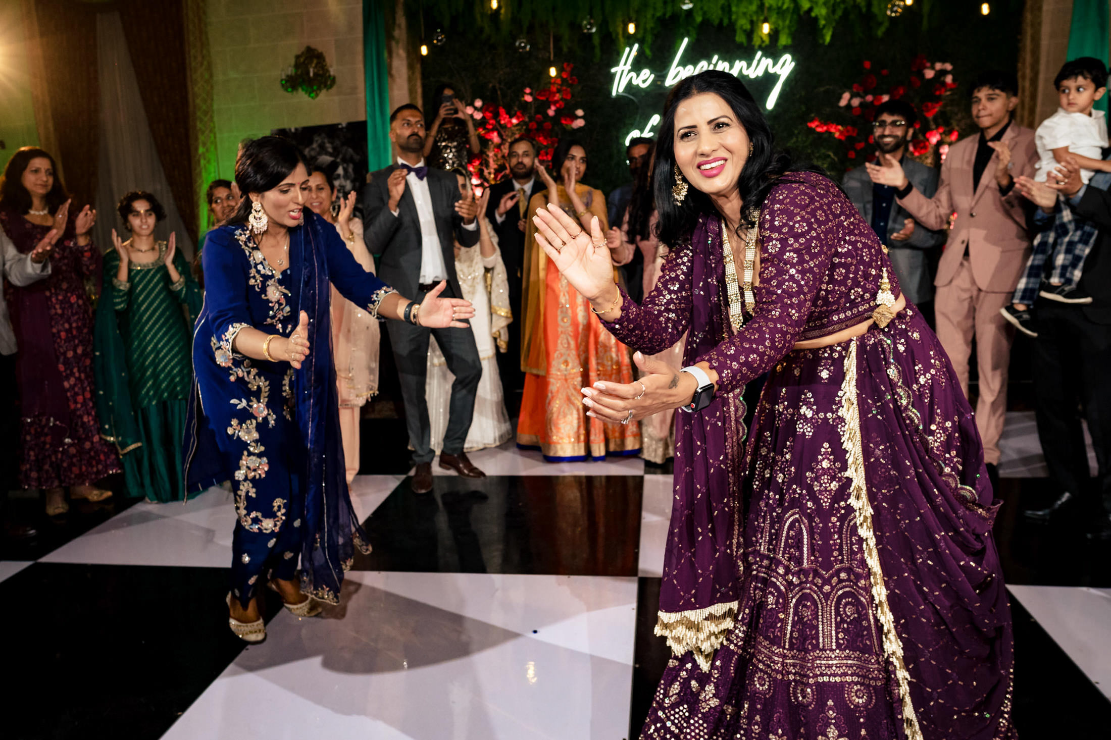 People dancing joyfully at a Winnipeg wedding, in colorful outfits and a lively atmosphere.