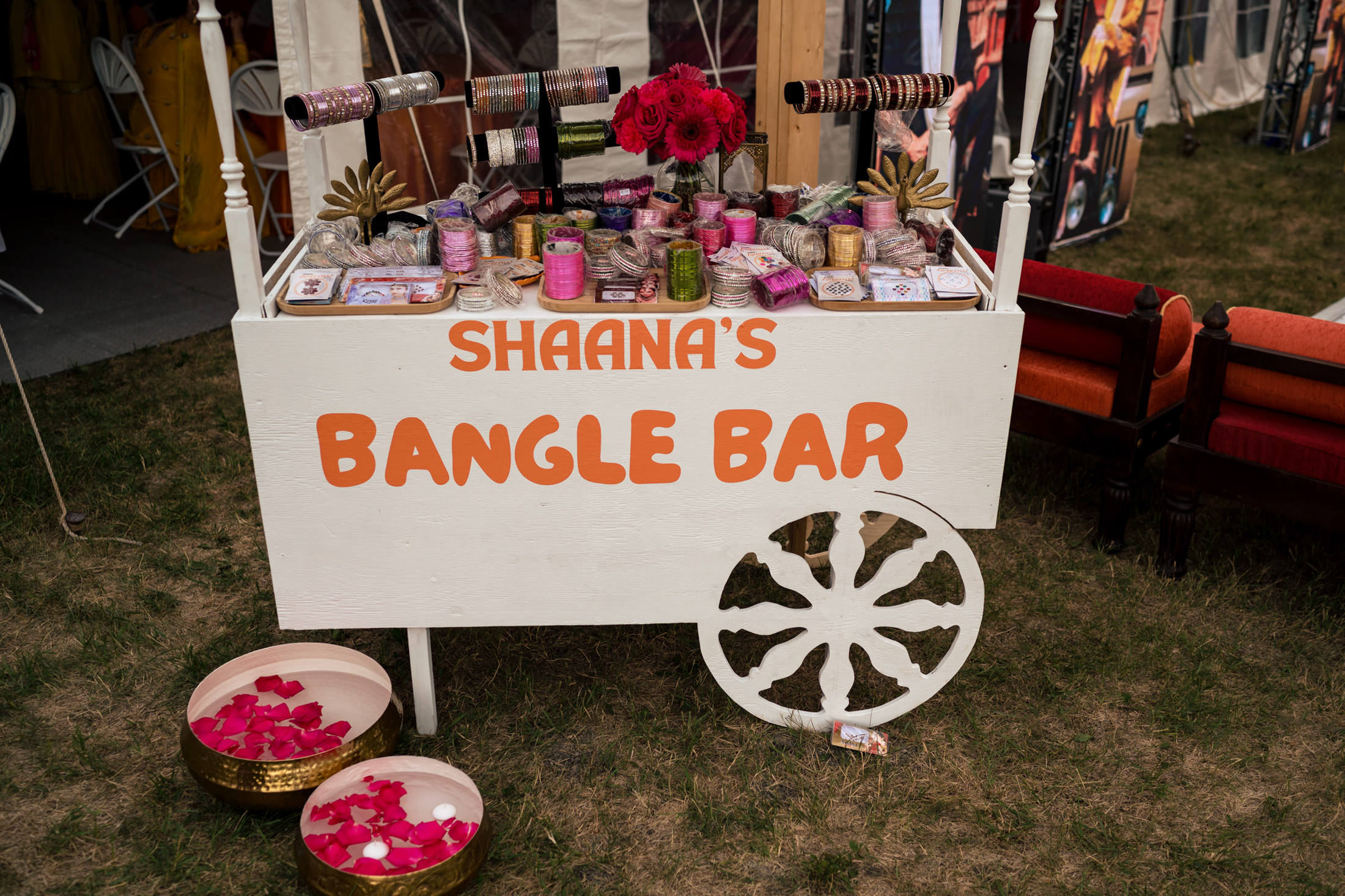 A bangle bar cart with vibrant bangles and flowers, titled "Shaana's Winnipeg Wedding Bangle Bar.