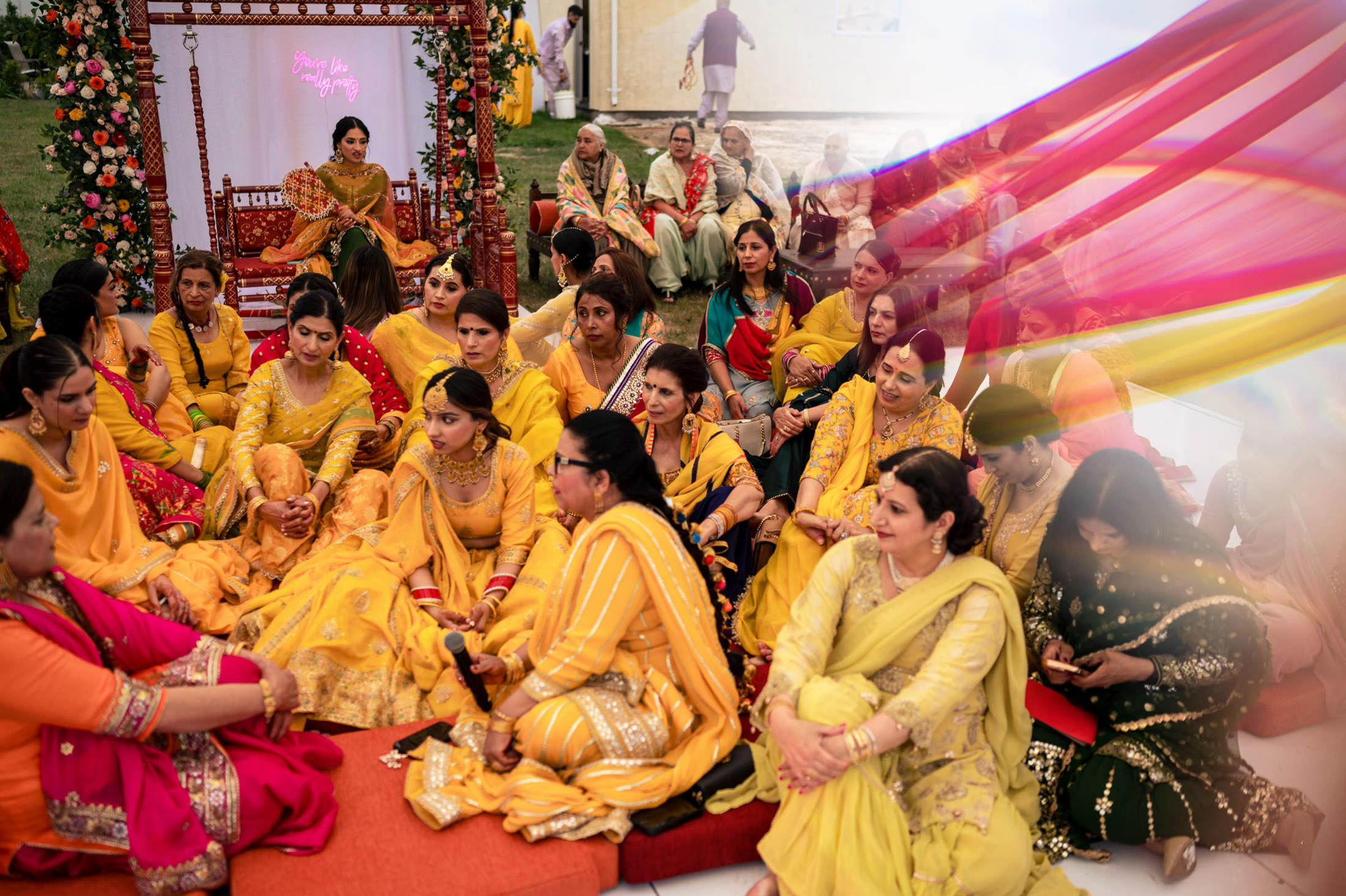 Group of women in colorful attire at a vibrant Winnipeg wedding celebration.