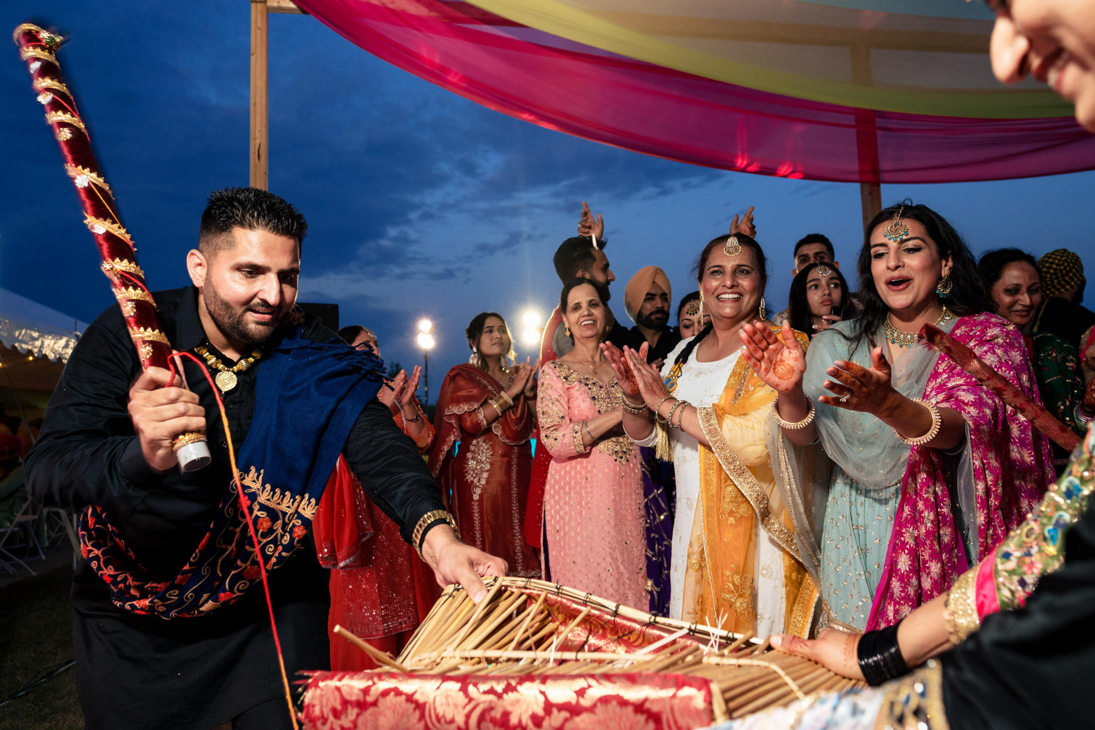 Dancing joyfully in colorful attire at a vibrant Winnipeg wedding celebration.