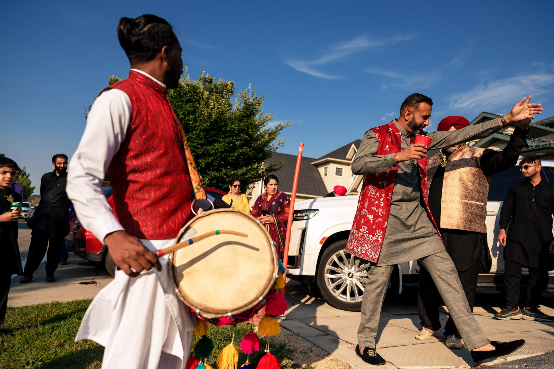 People in colorful attire celebrate with dance and drums at a Winnipeg wedding.