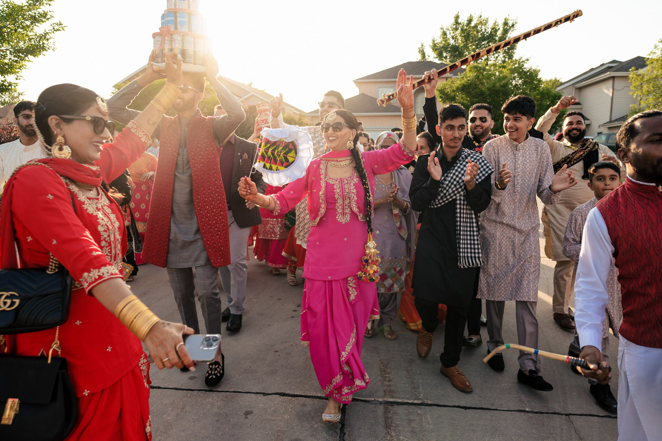 People celebrating a Winnipeg wedding with dance and colorful attire in an outdoor festivity.