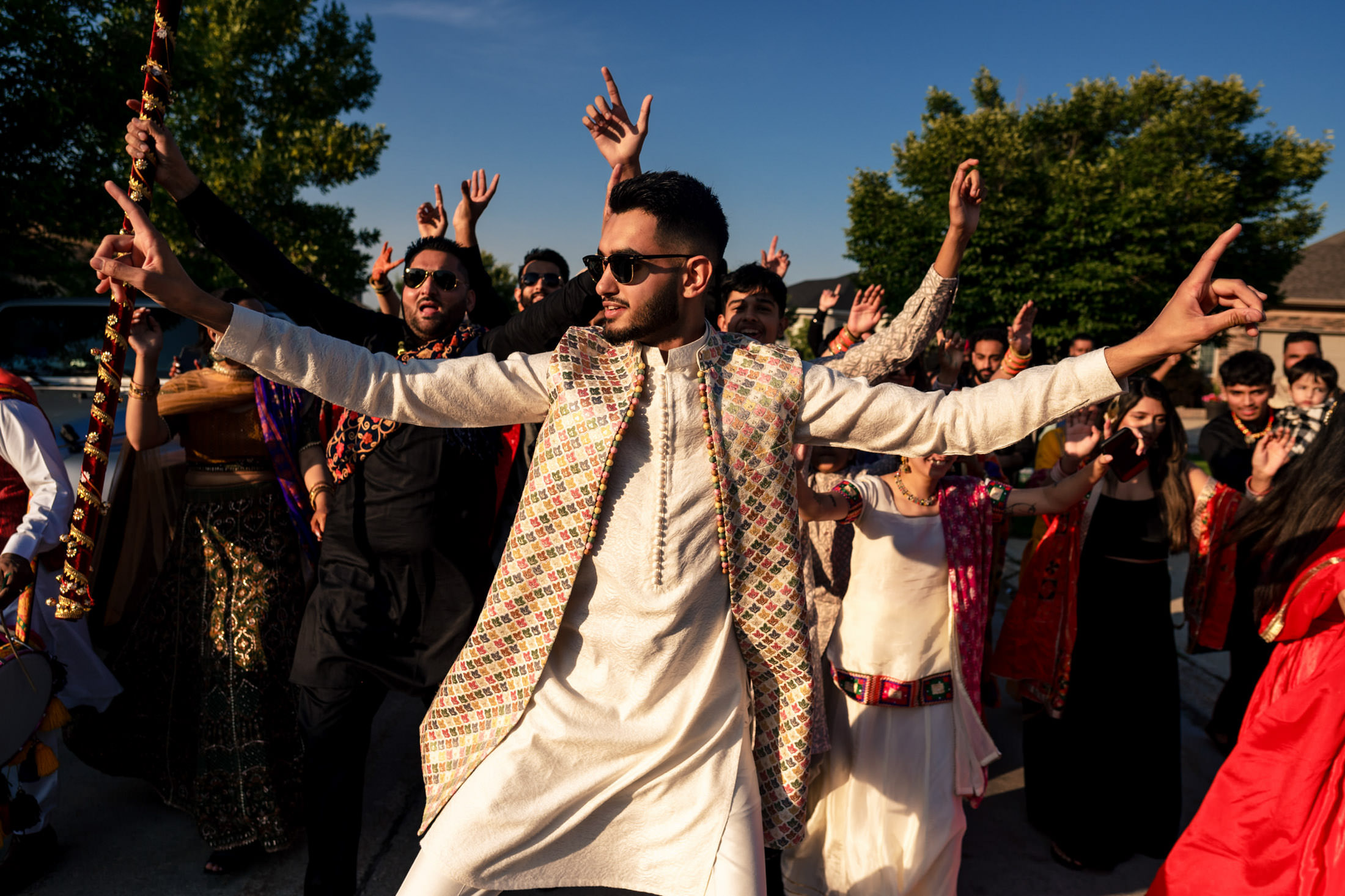 Person in festive attire dances energetically at a lively Winnipeg wedding.