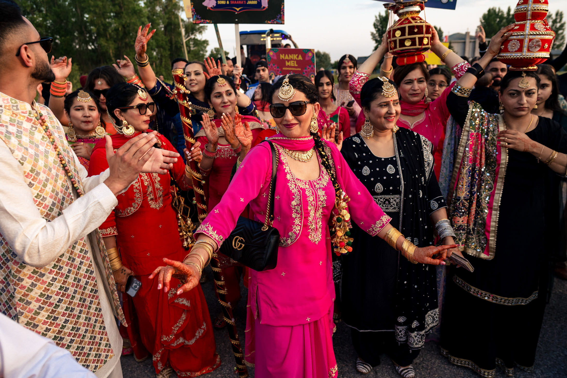 Women in vibrant traditional attire dancing at a Winnipeg wedding celebration.