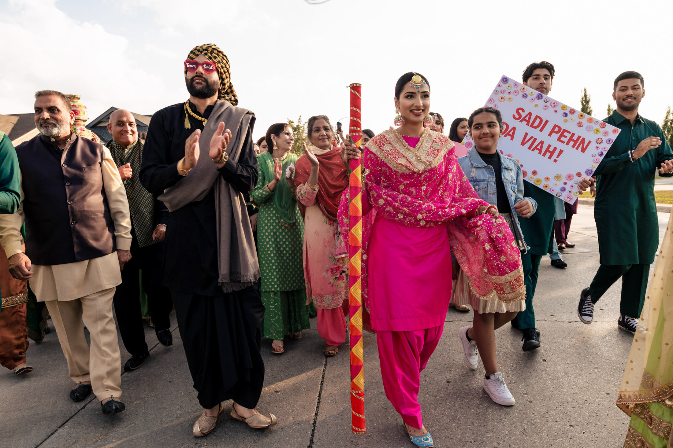 A joyful group celebrates with music and dancing at a Winnipeg wedding.