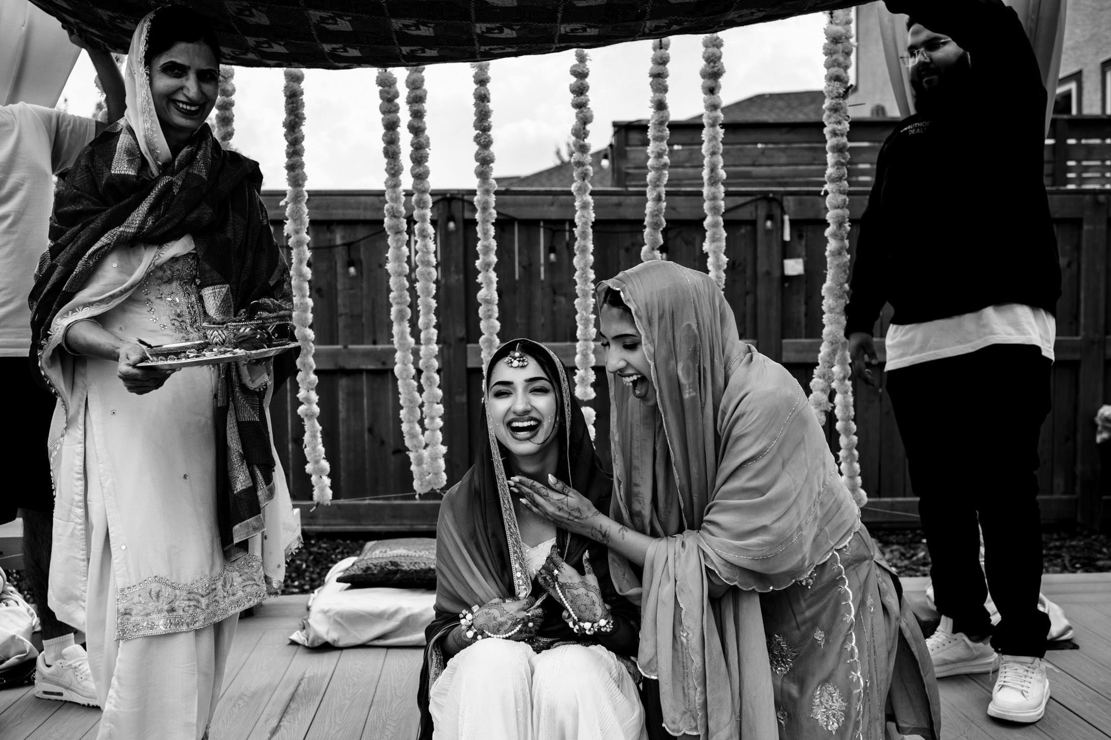 Women in traditional attire celebrating at a Winnipeg wedding with decorations.
